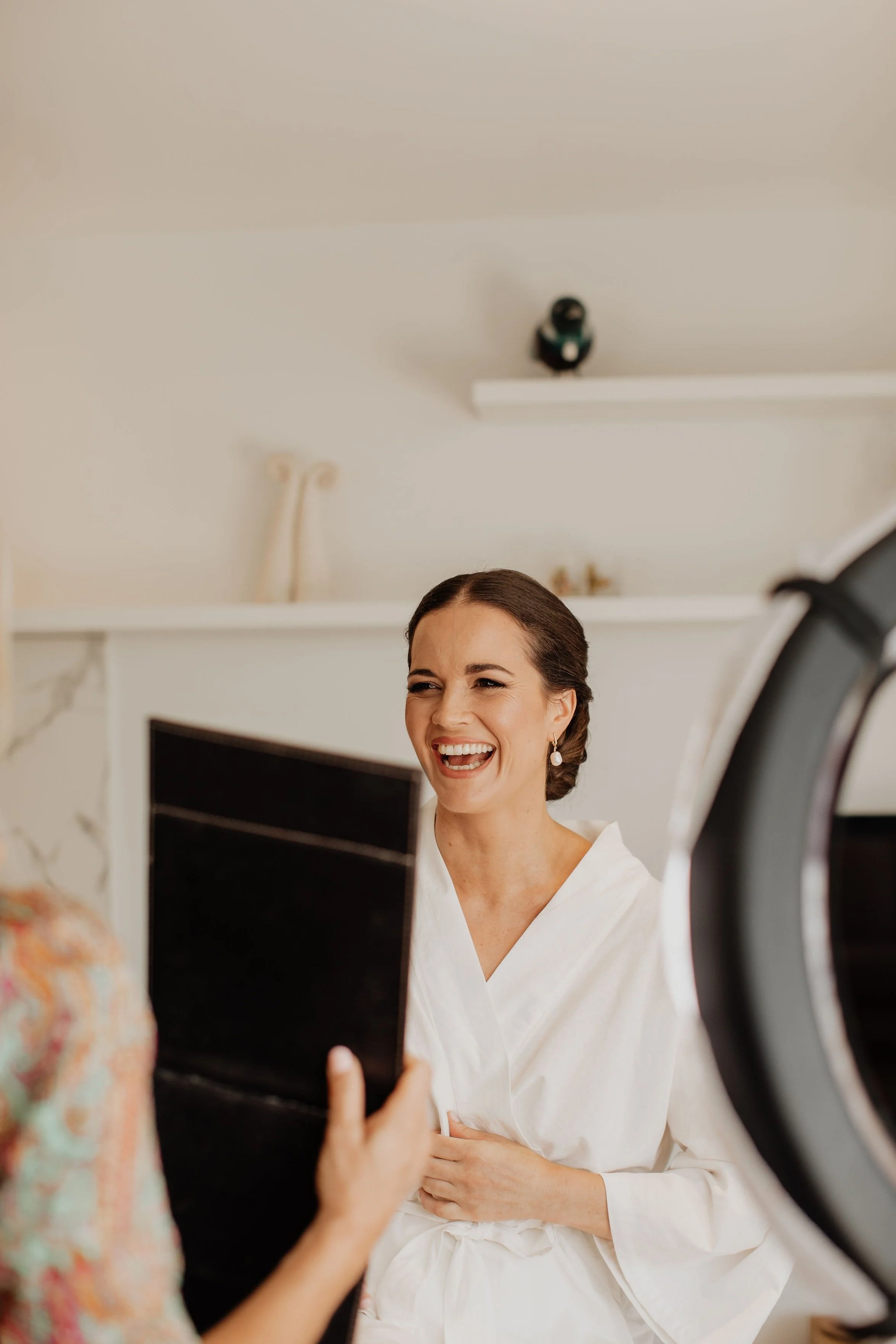 happy-bride-looking-in-mirror-makeup-artist-tauranga.jpg