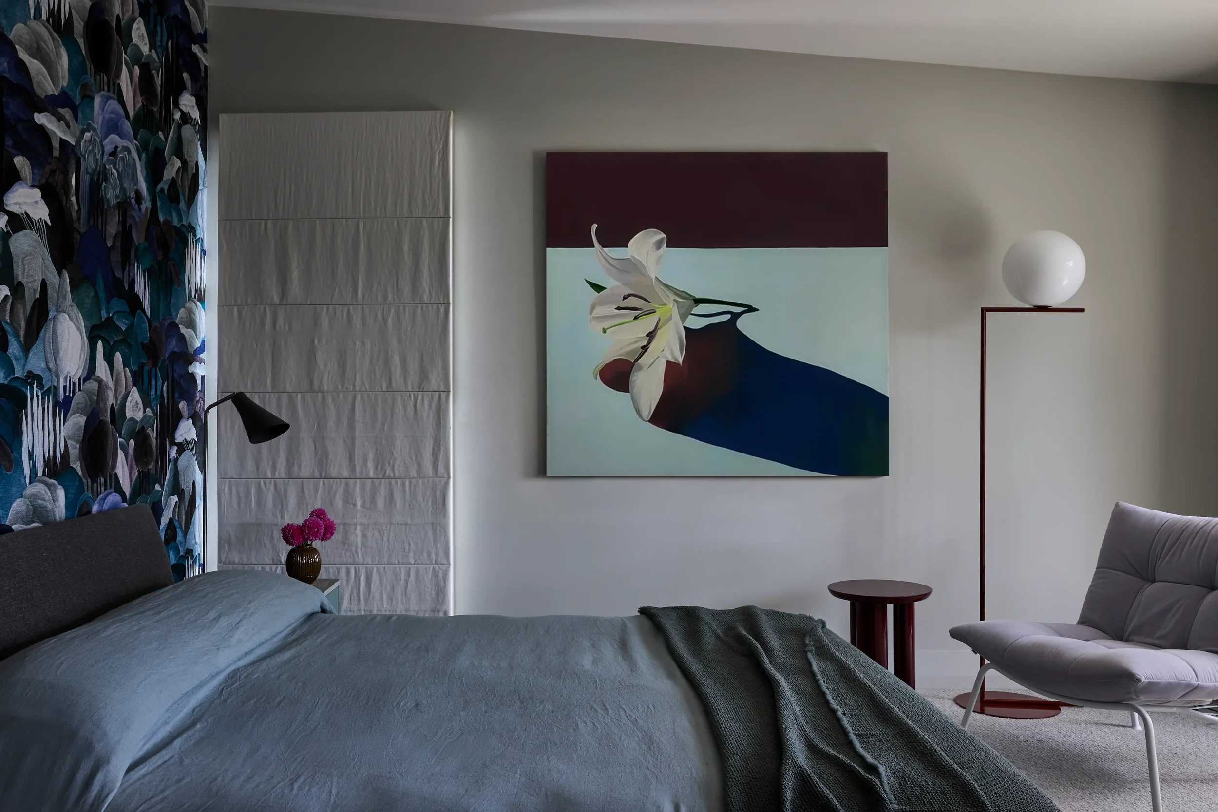 Balmoral Reverie master bedroom featuring bold floral wallpaper and cool jewel tones