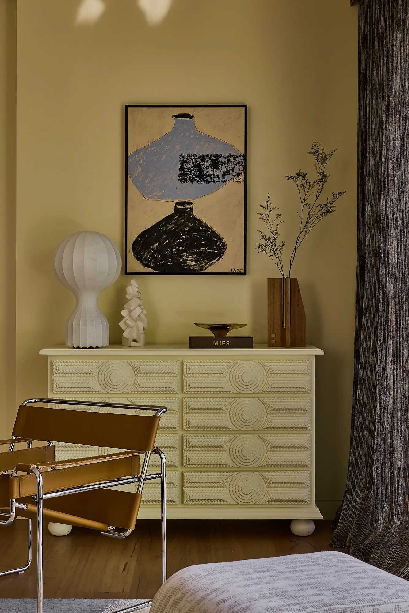 Balmoral Reverie living room detail with yellow drawers, artwork and marigold interior walls