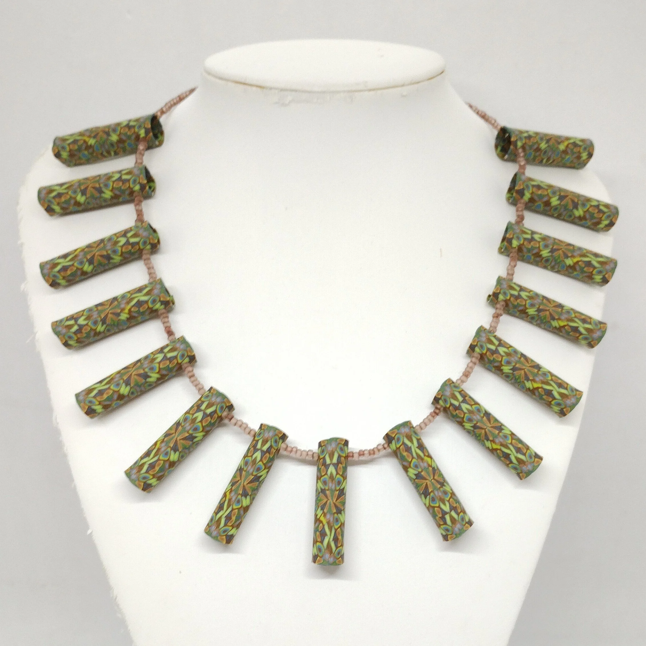 Brown patterned tube bead necklace on model