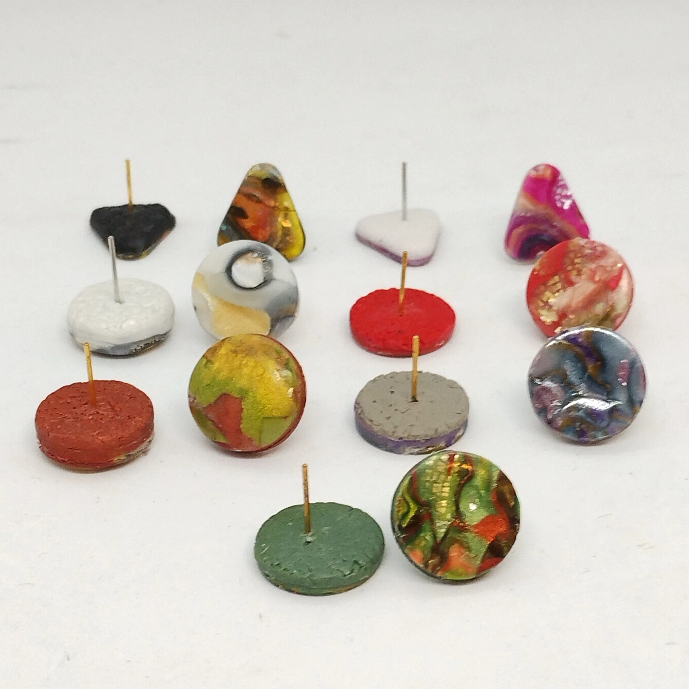 collection of patterned stud earrings showing textured backs