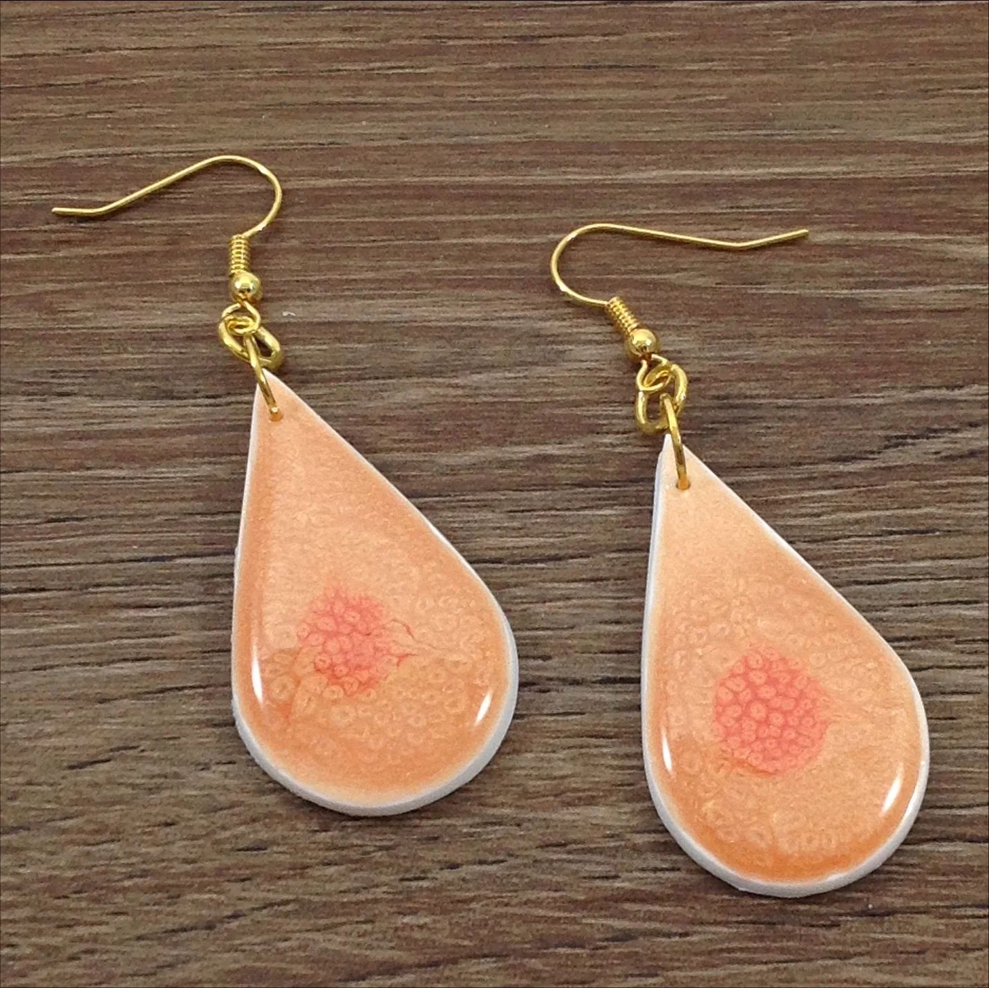 orange painted white polymer clay drop shape earrings