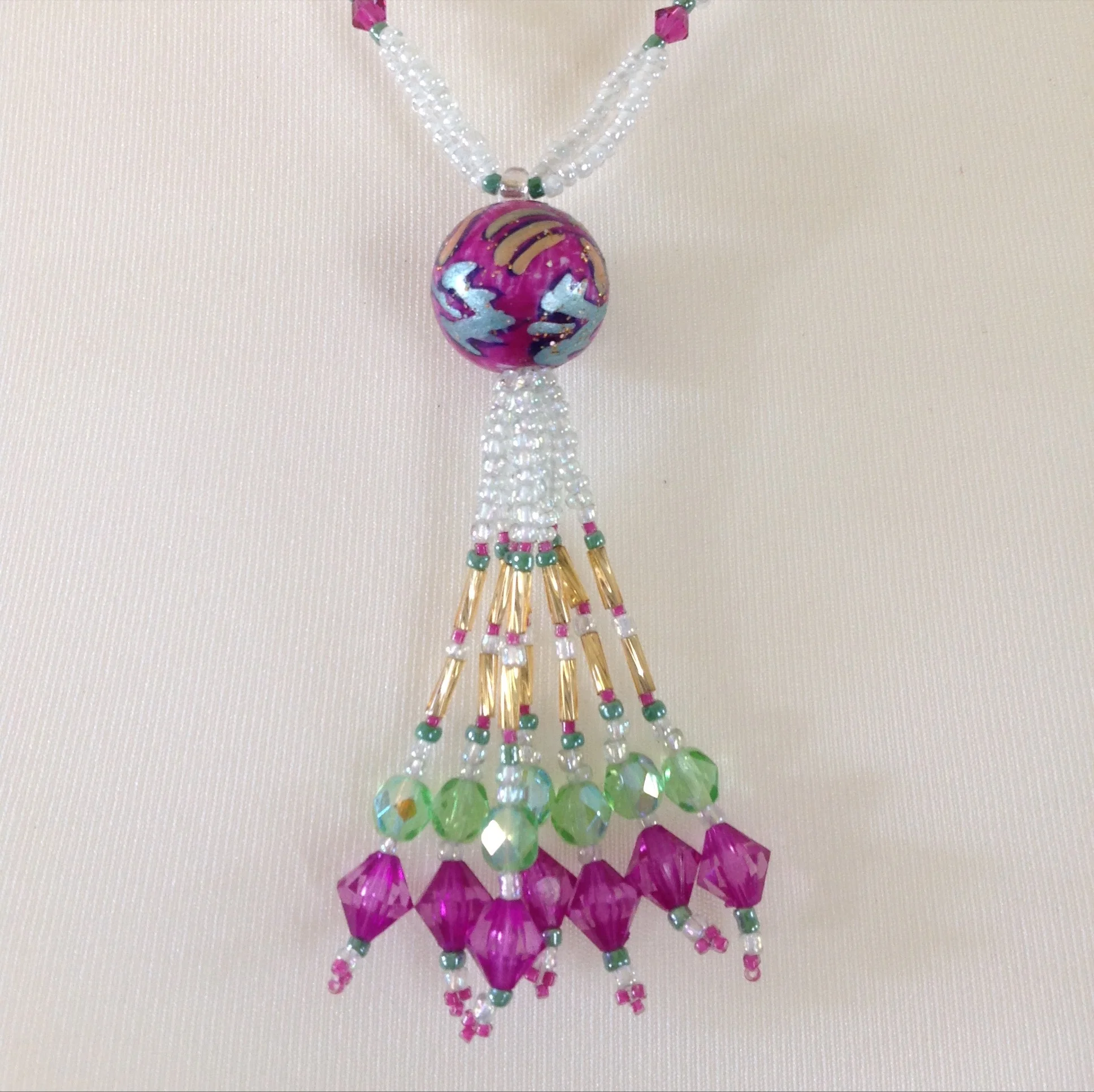 pink green white tasseled bead necklace detail