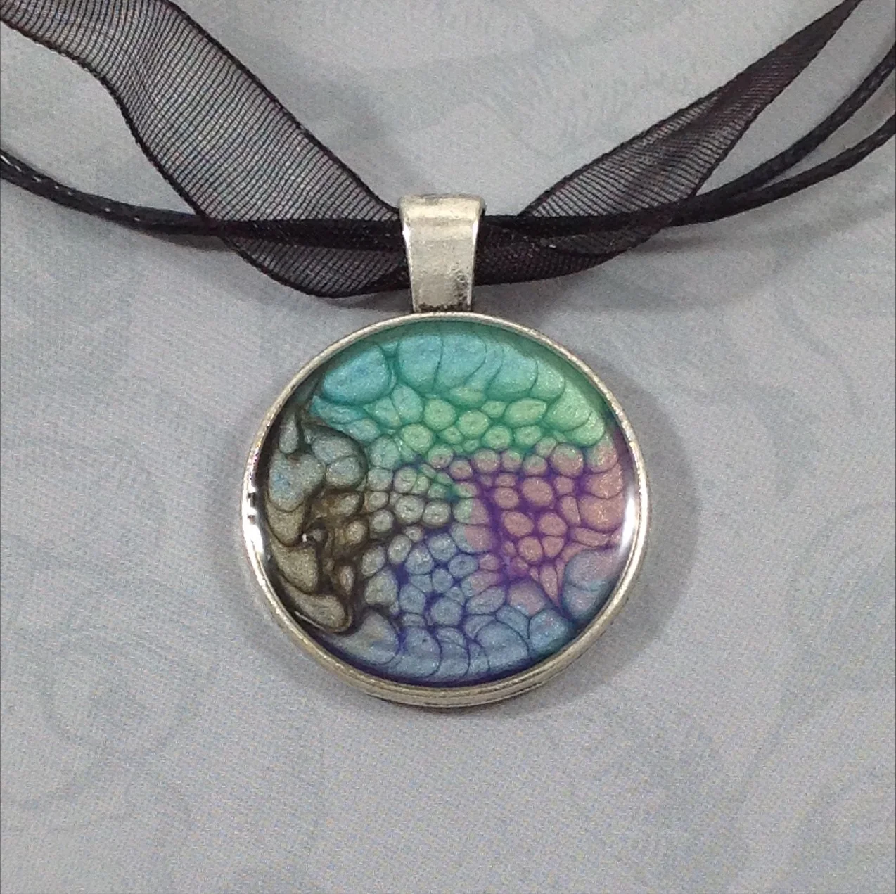 black green purple pebeo painted round pendant on ribbon