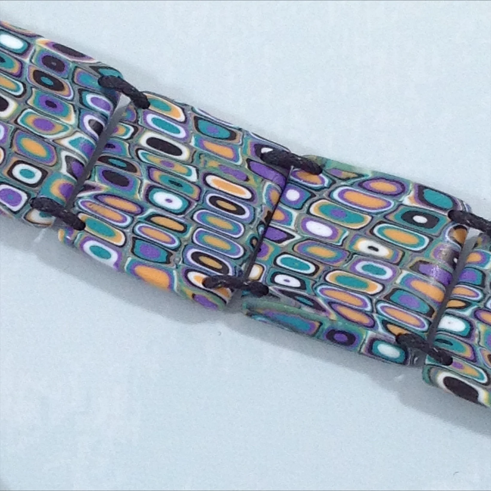 green purple and yellow polymer clay square bead bracelet detail