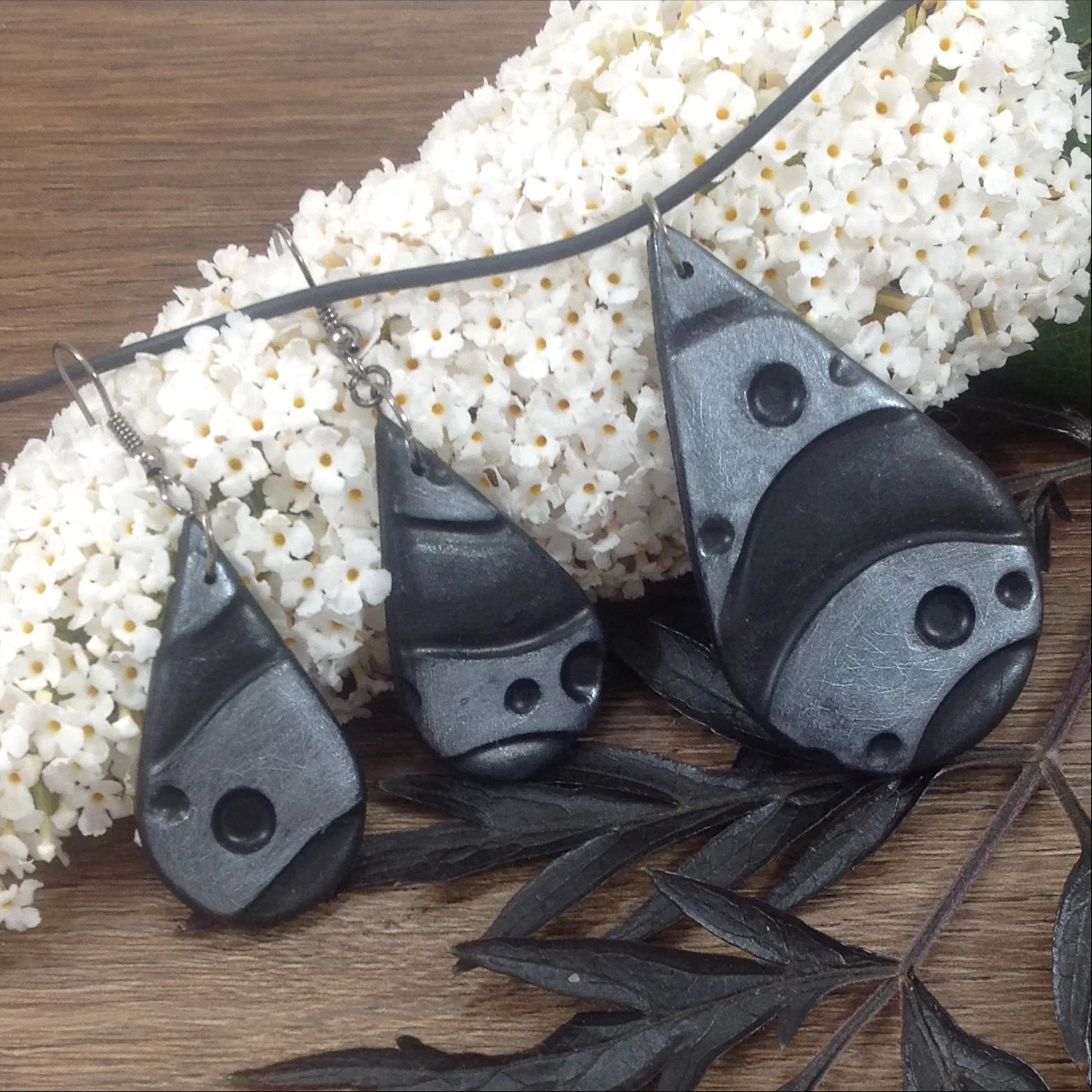 black polymer clay teardrop shape silver design earrings and pendant