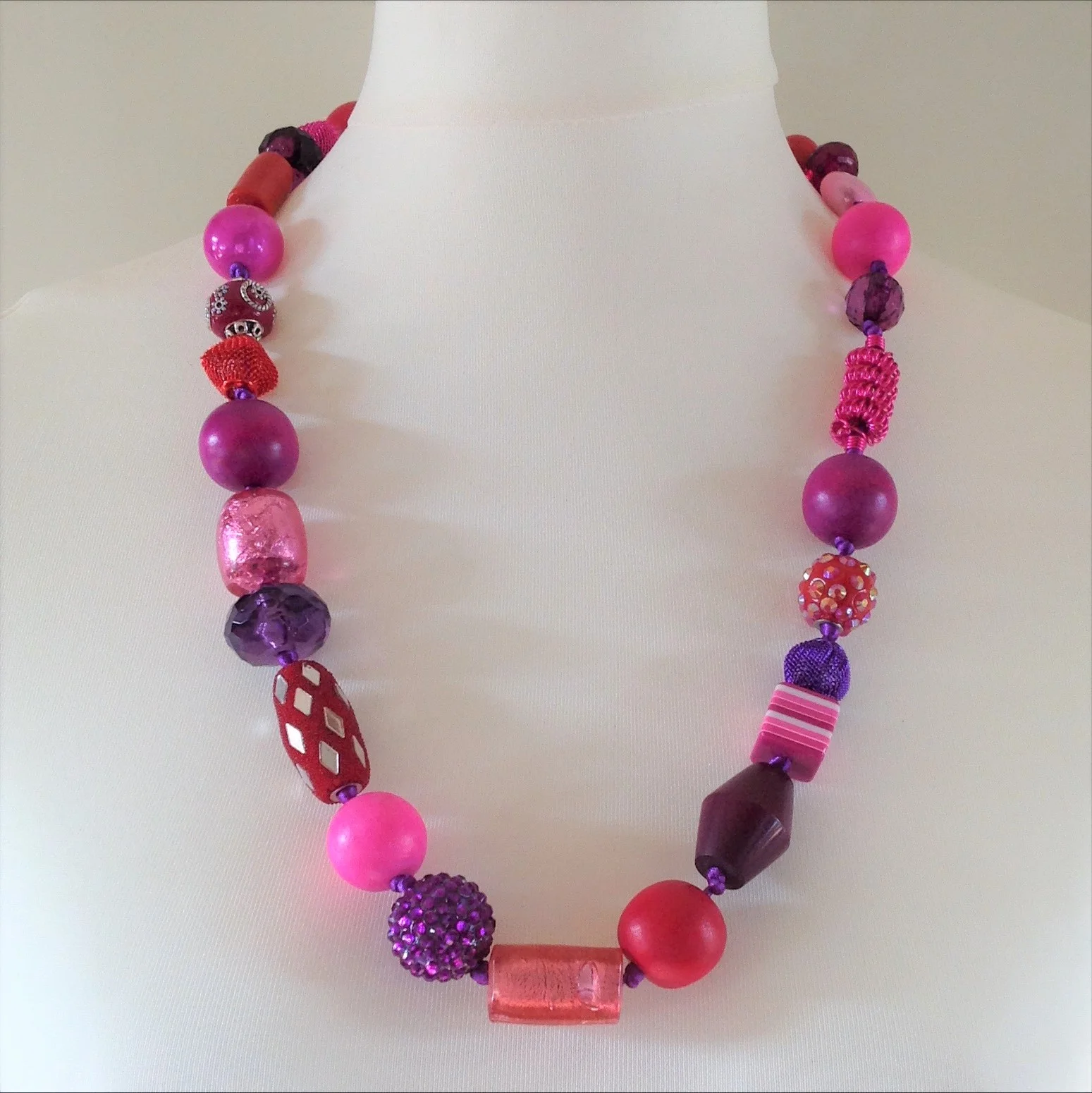 pink purple mixed bead hand knotted long necklace on stand