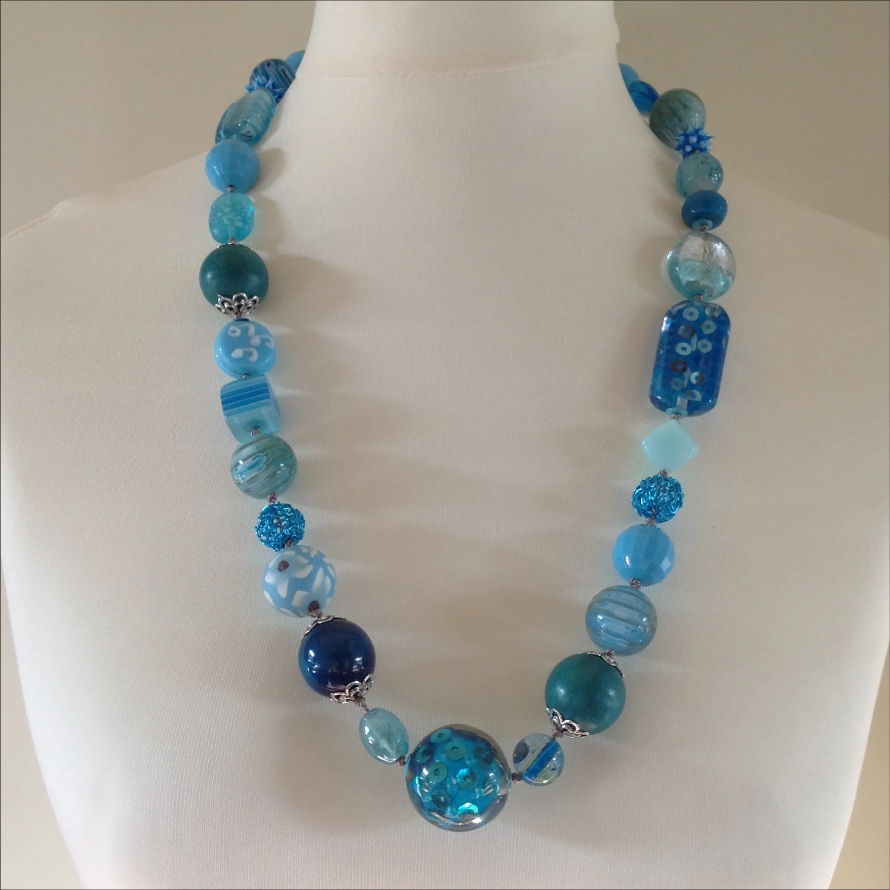 turquoise colour mixed bead hand knotted long necklace on stand