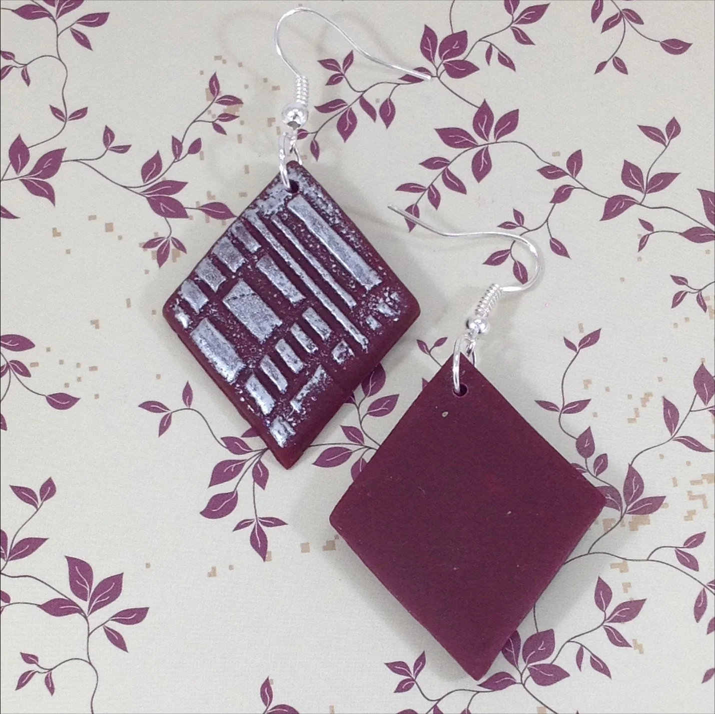 wine colour polymer clay diamond shape drop earrings with silver colour embossed decoration back view