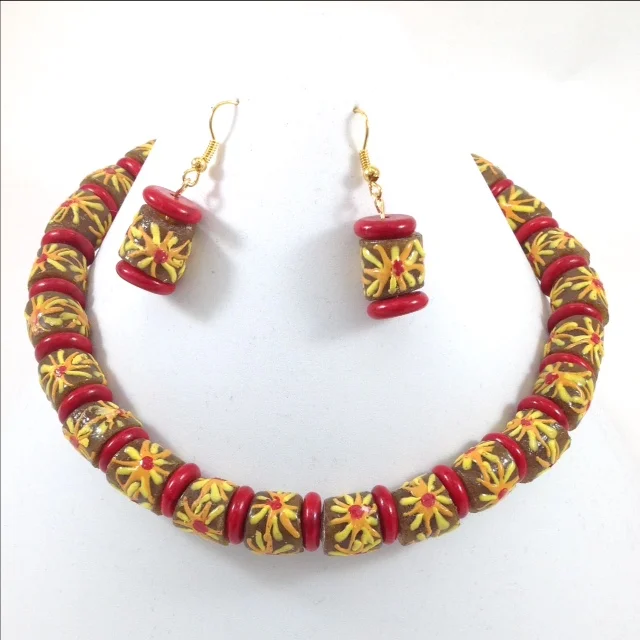 brown yellow flower design krobe glass bead Ghana necklace and earrings on stand