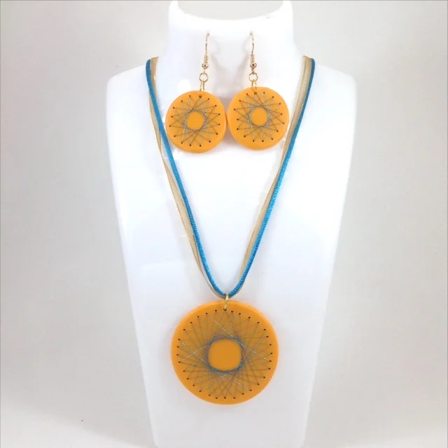 embroidered polymer clay round pendant and earrings yellow