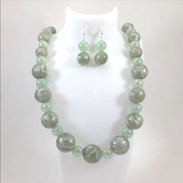 grey green mokume gane polymer clay bead necklace and earrings on stand