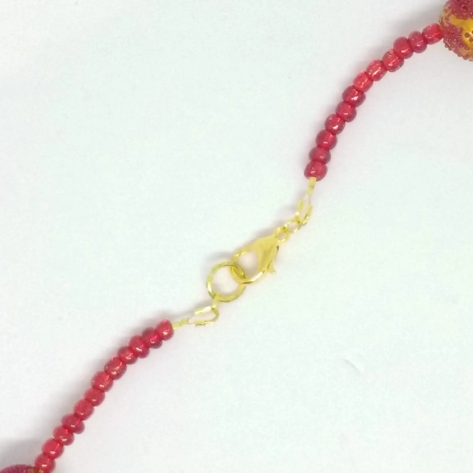 Polymer clay necklace red and gold colours back fastening detail