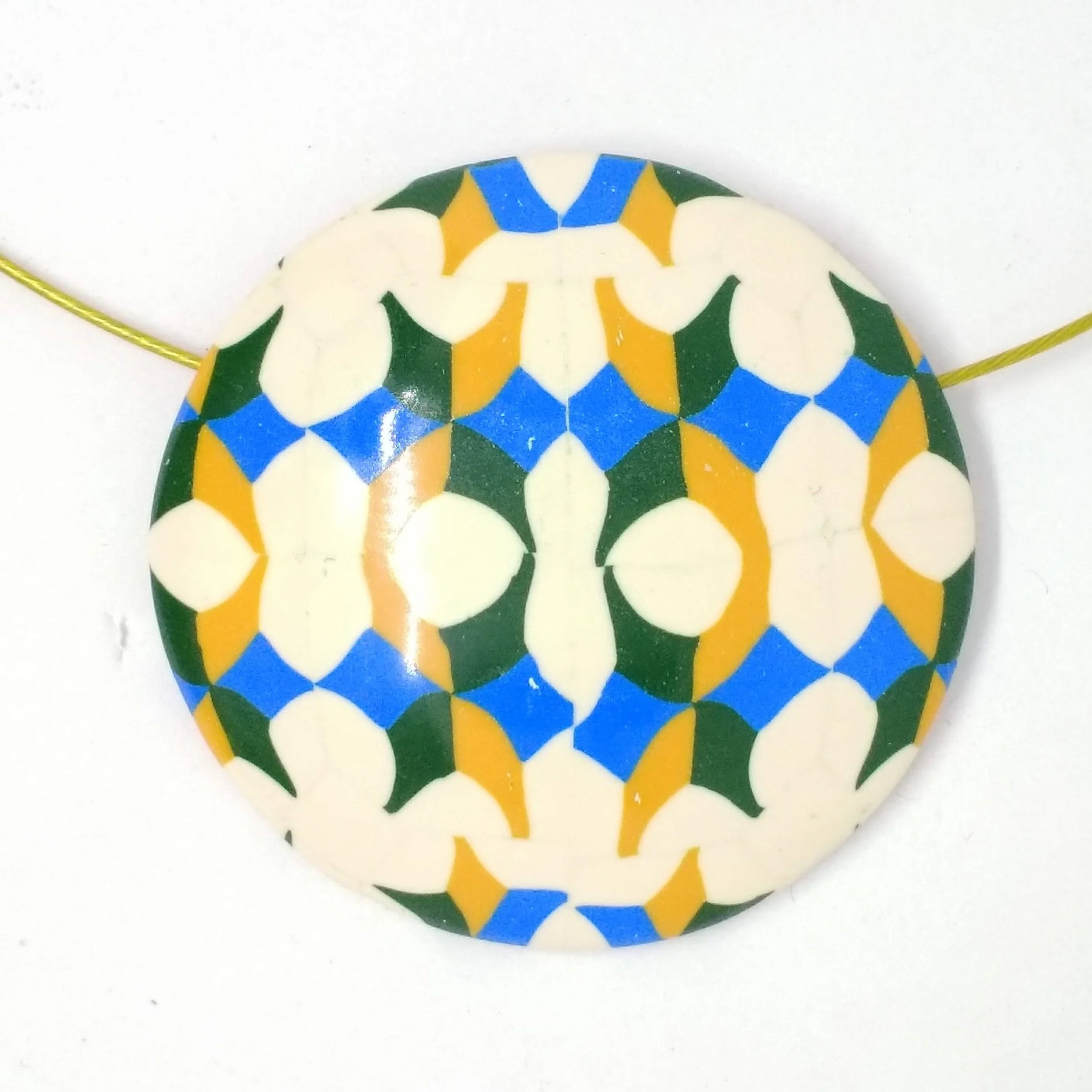 Polymer clay round pendant white, blue, green yellow pattern