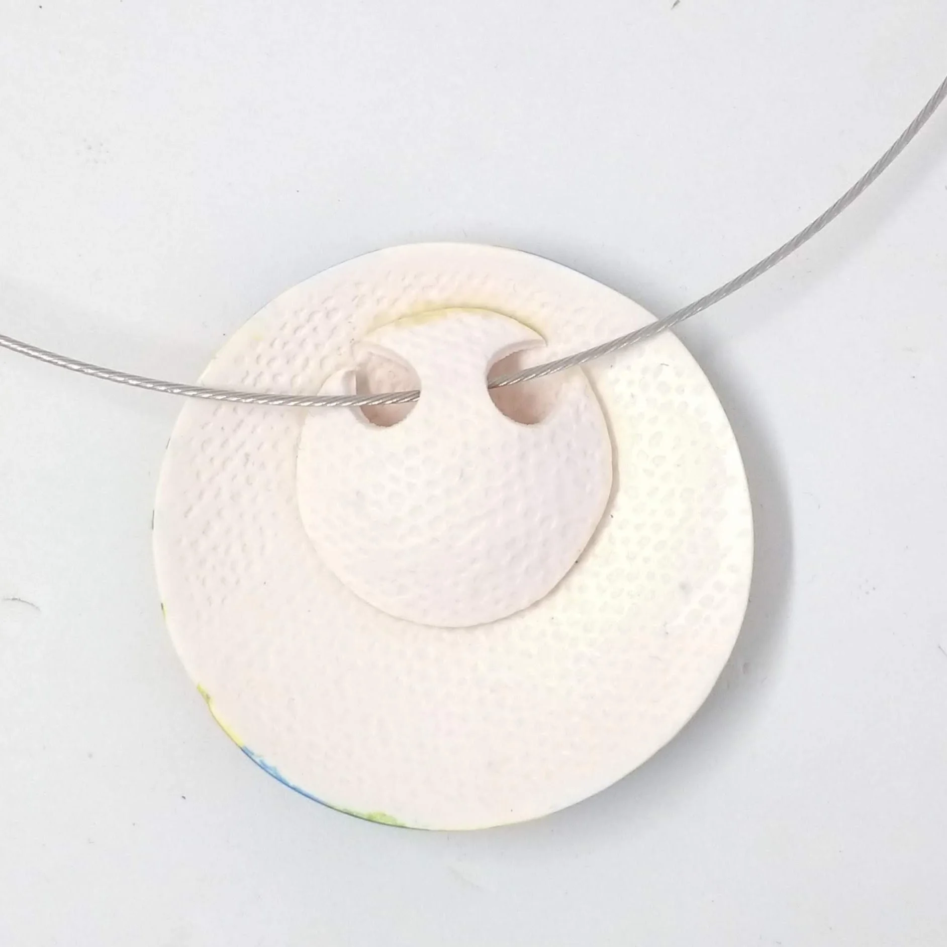 Polymer clay round pendant white, blue, green yellow pattern back detail