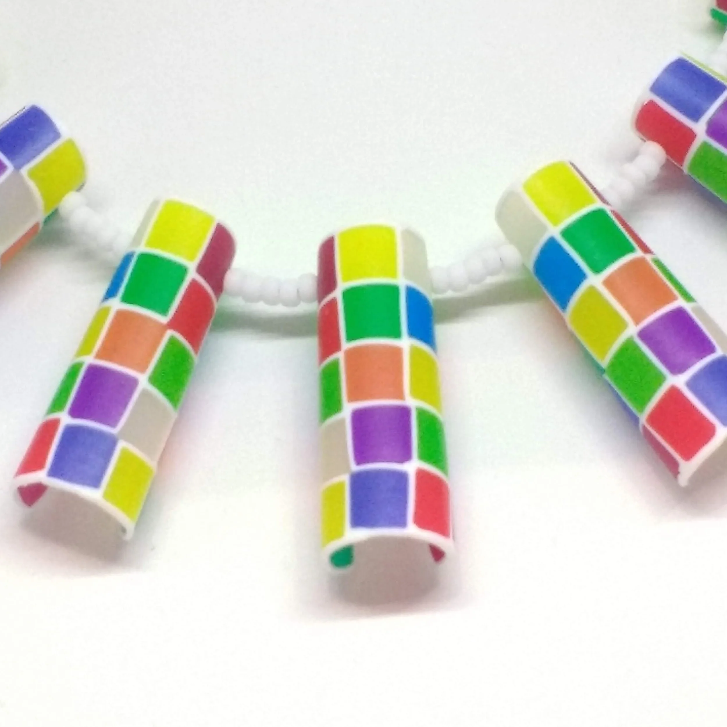 Polymer clay multicolour tube shapes necklace close up