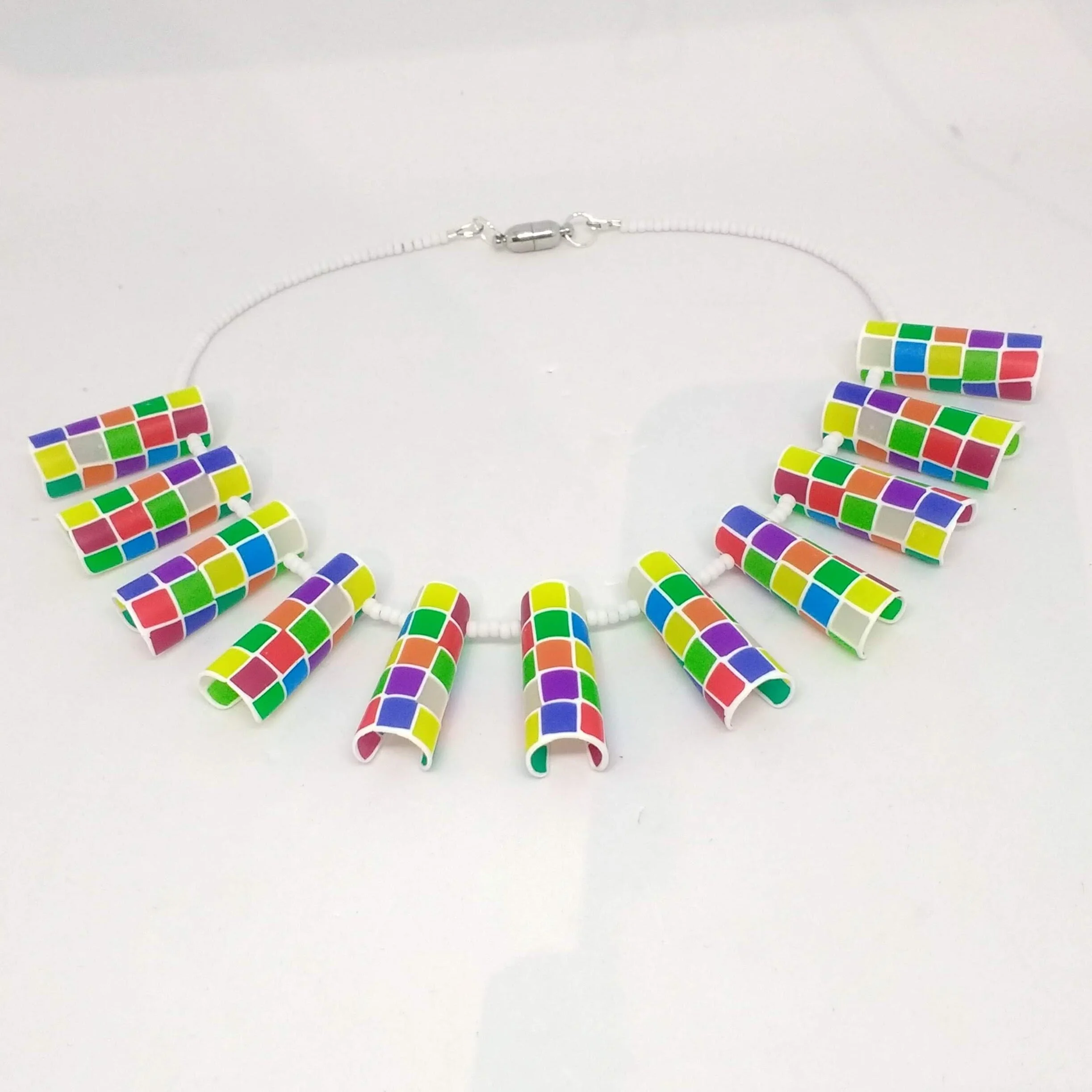 Polymer clay multicolour tube shapes necklace showing magneticfastening