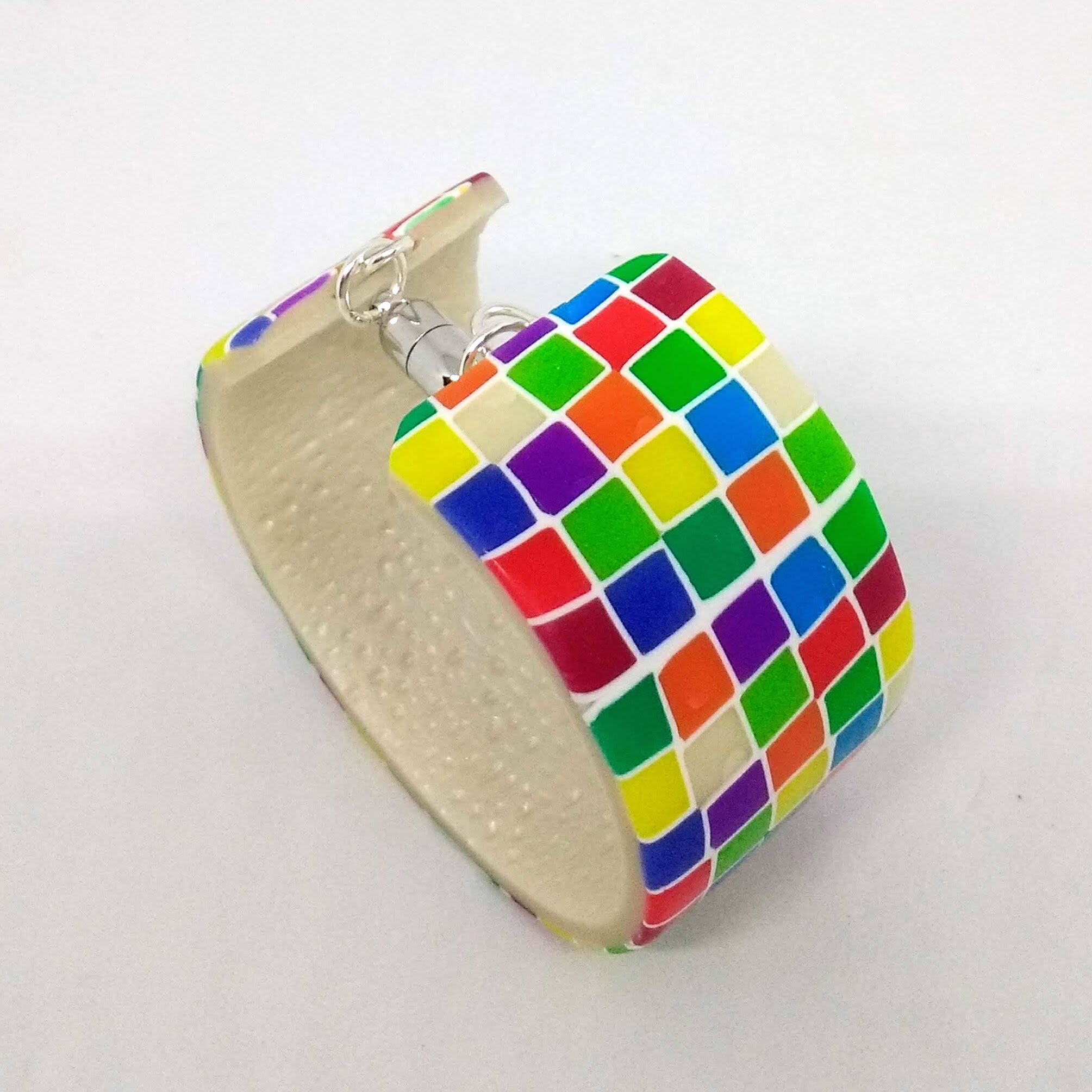 Polymer clay bracelet with multicoloured square designshowing magnetic fastening and textured inside
