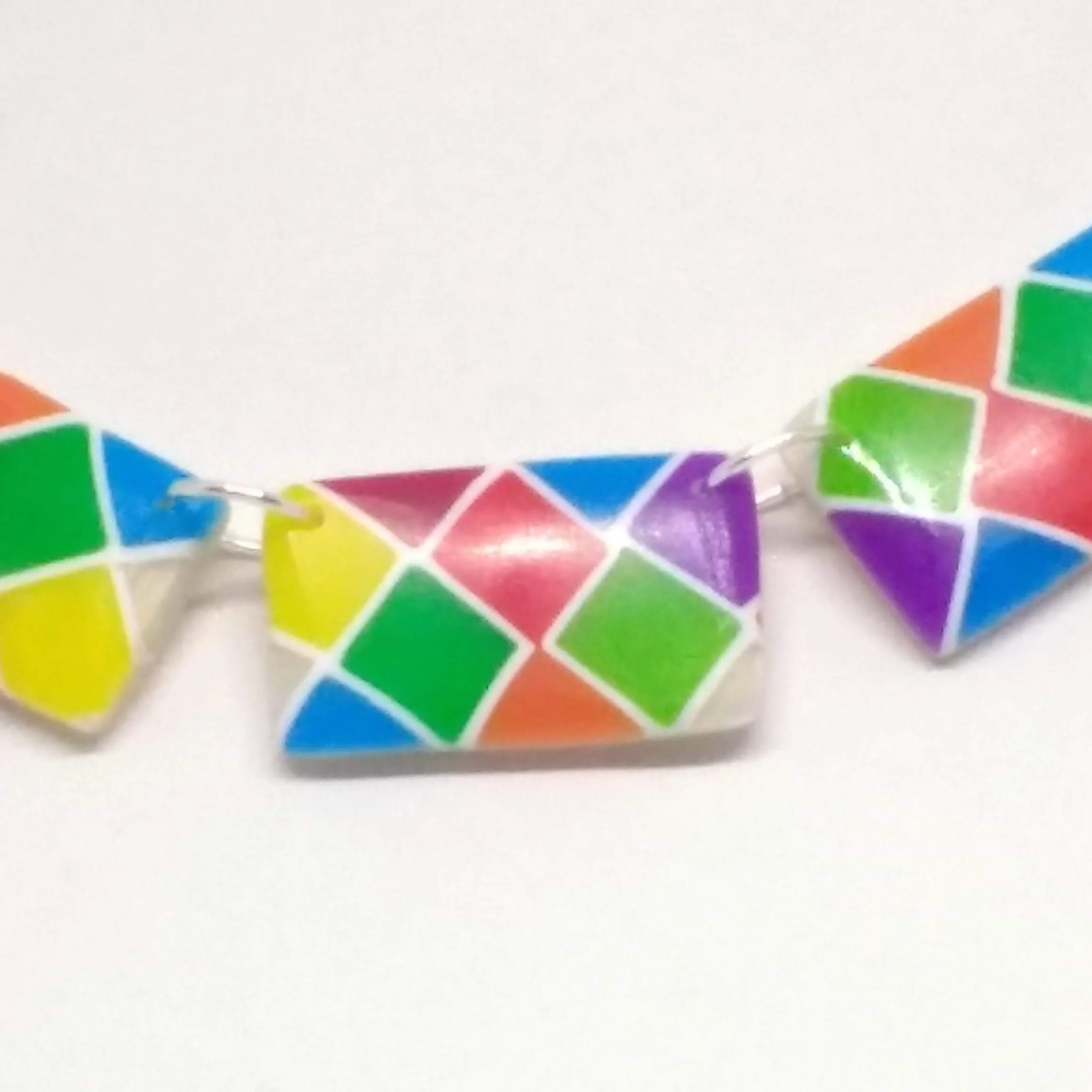Polymer clay necklace with oblong beads with bright coloured square design detail