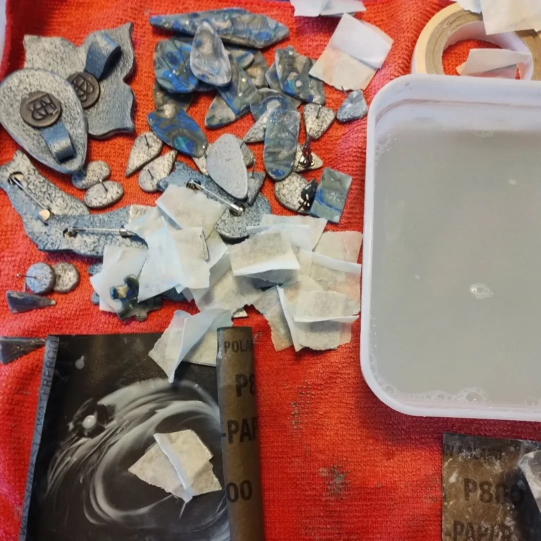 This is the unglamorous part of making polymer clay jewellery.  Sanding is boring and messy and hard on the nails and fingers, but the finished shine is well worth the effort I think.

#handmadejewellerydesigns #polymerclayjewellery #buyhandmadethisc