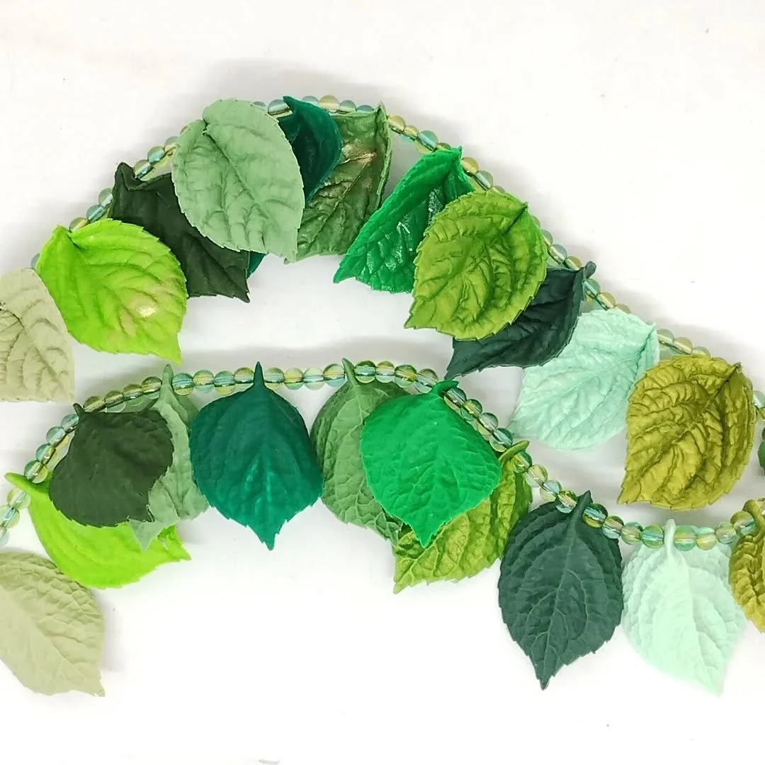 Not very Spring like today, so I bring you a Spring leaves necklace to remind you that the first leaves of spring are ready to burst into life.

Each leaf is textured on both sides and in lots of shades of green.

#springleaves #polymerclaynecklace #