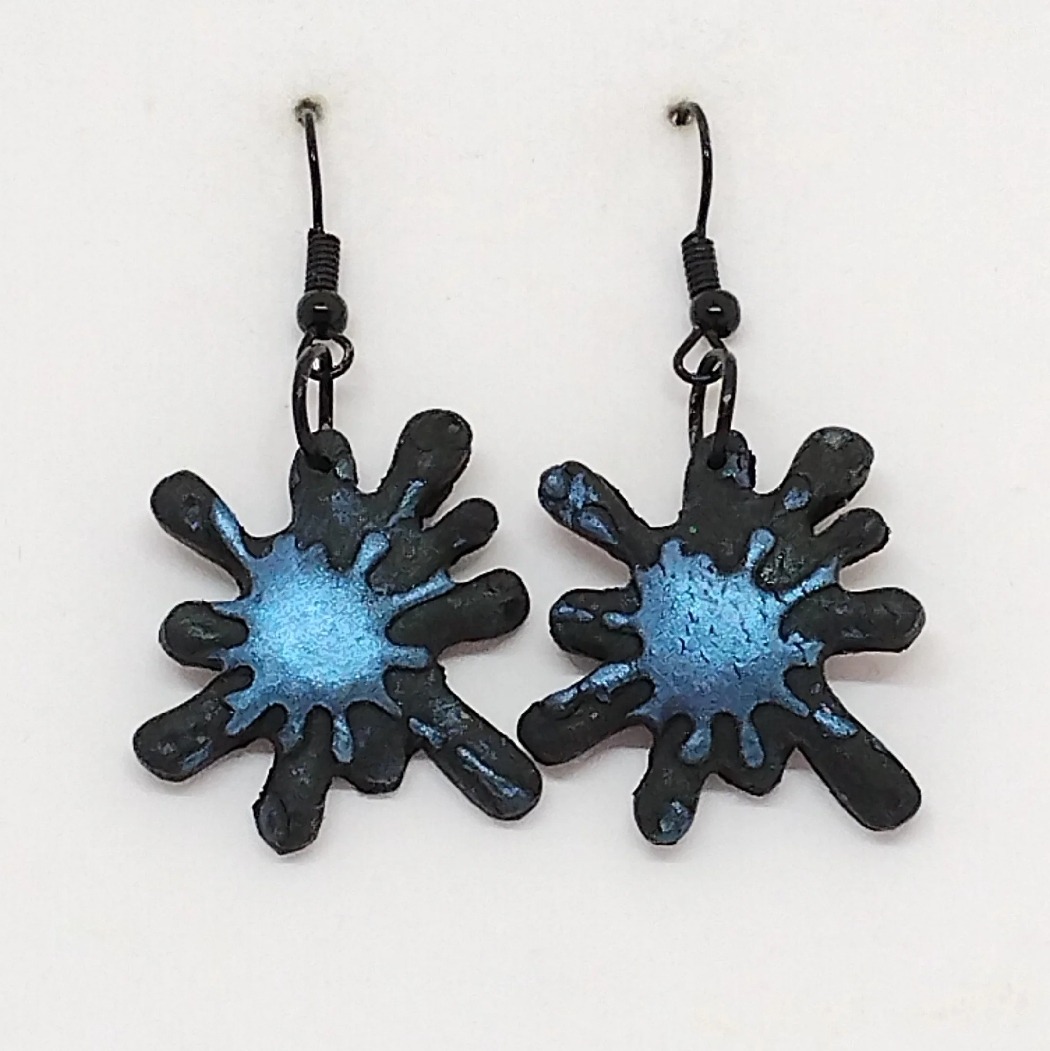 Black splash shape earrings with blue raindrop design
