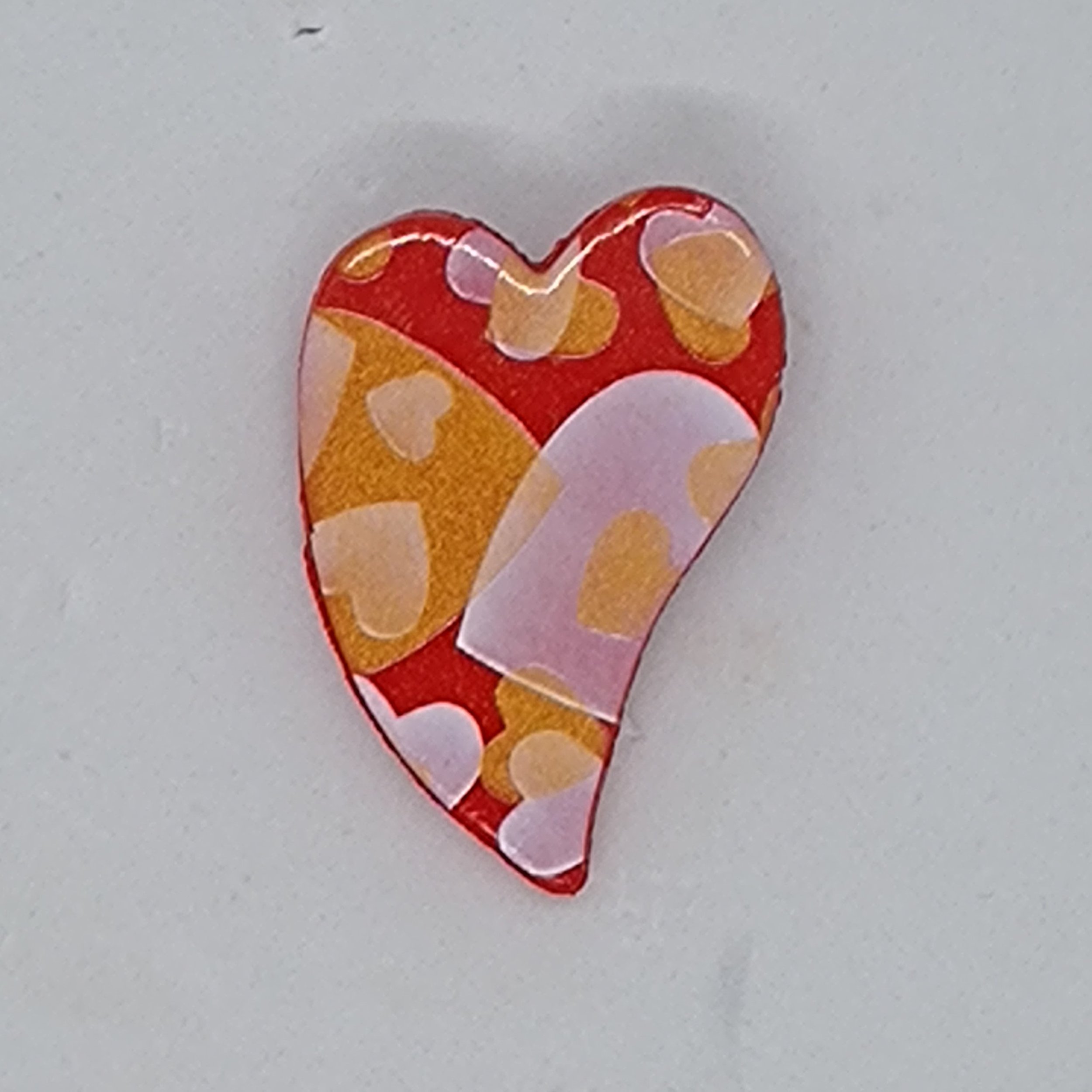 Red heart shape brooch with gold heart design