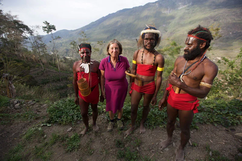 Libby hiking into the Baliem Valley with local porters from the Lani and Dani tribes.