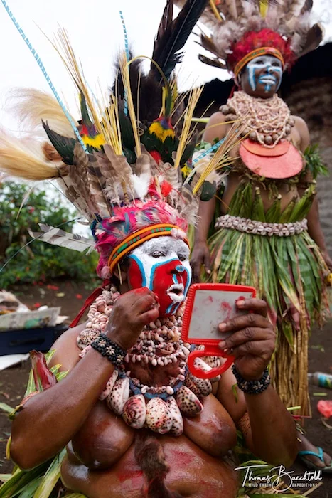 Tribesman applying make up, Goroka - Papua New Guinea - Wild Earth Expeditions