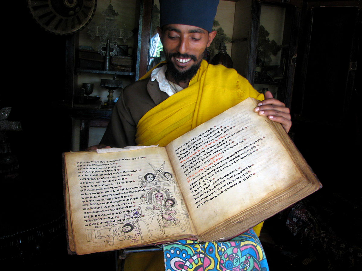 ETH_Lake-Tana-Azwa-Mariam-Monastery-Monk-w-Manuscript-©-Dinkesh-Ethiopia-Tours1.jpg