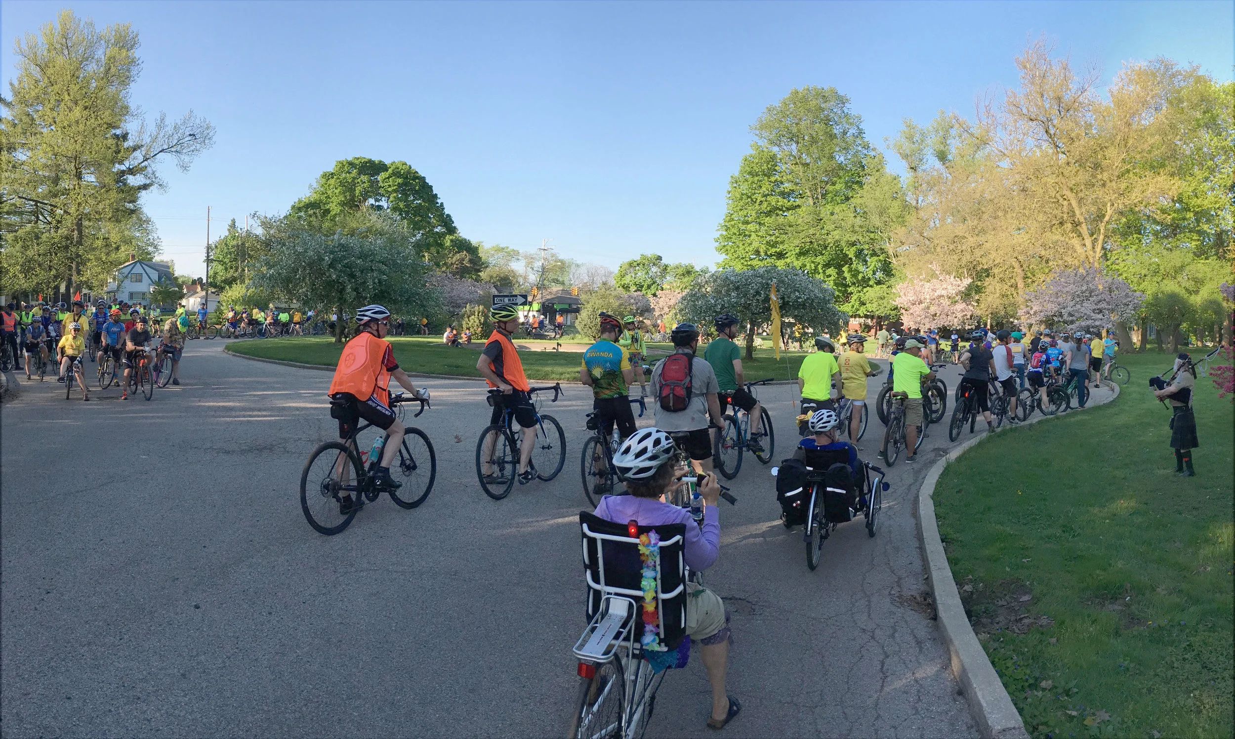 A bagpiper plays in remembrance as riders stop around John Ball Park Circle.