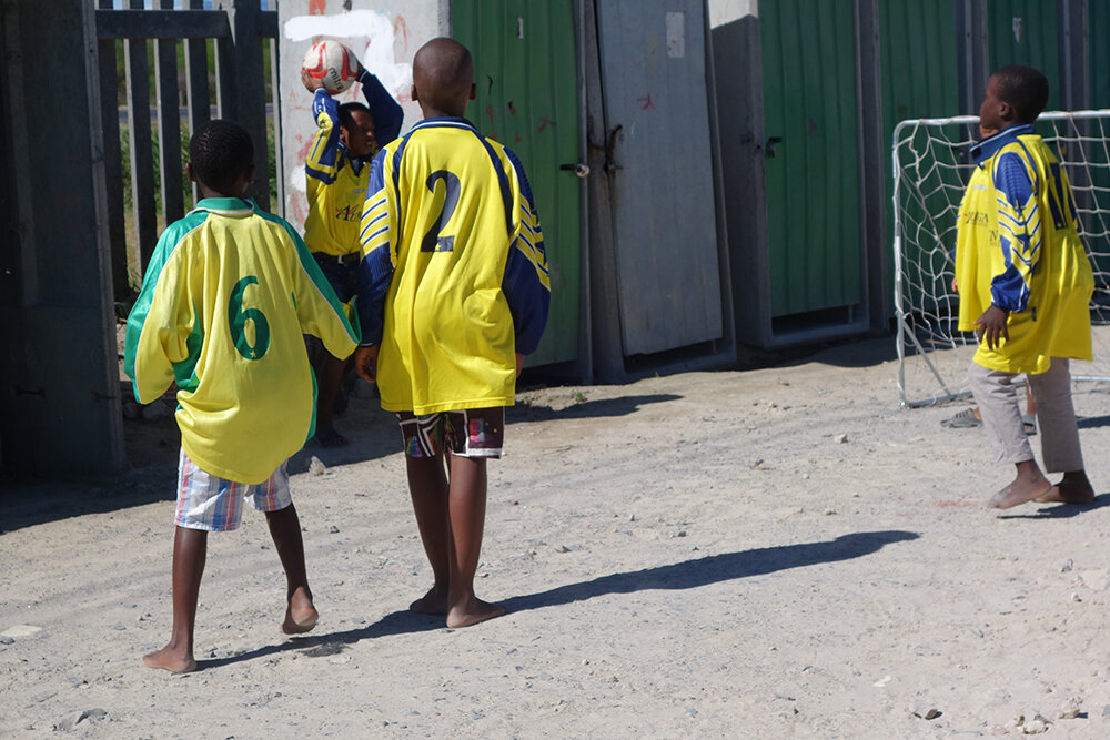 Children play barefoot