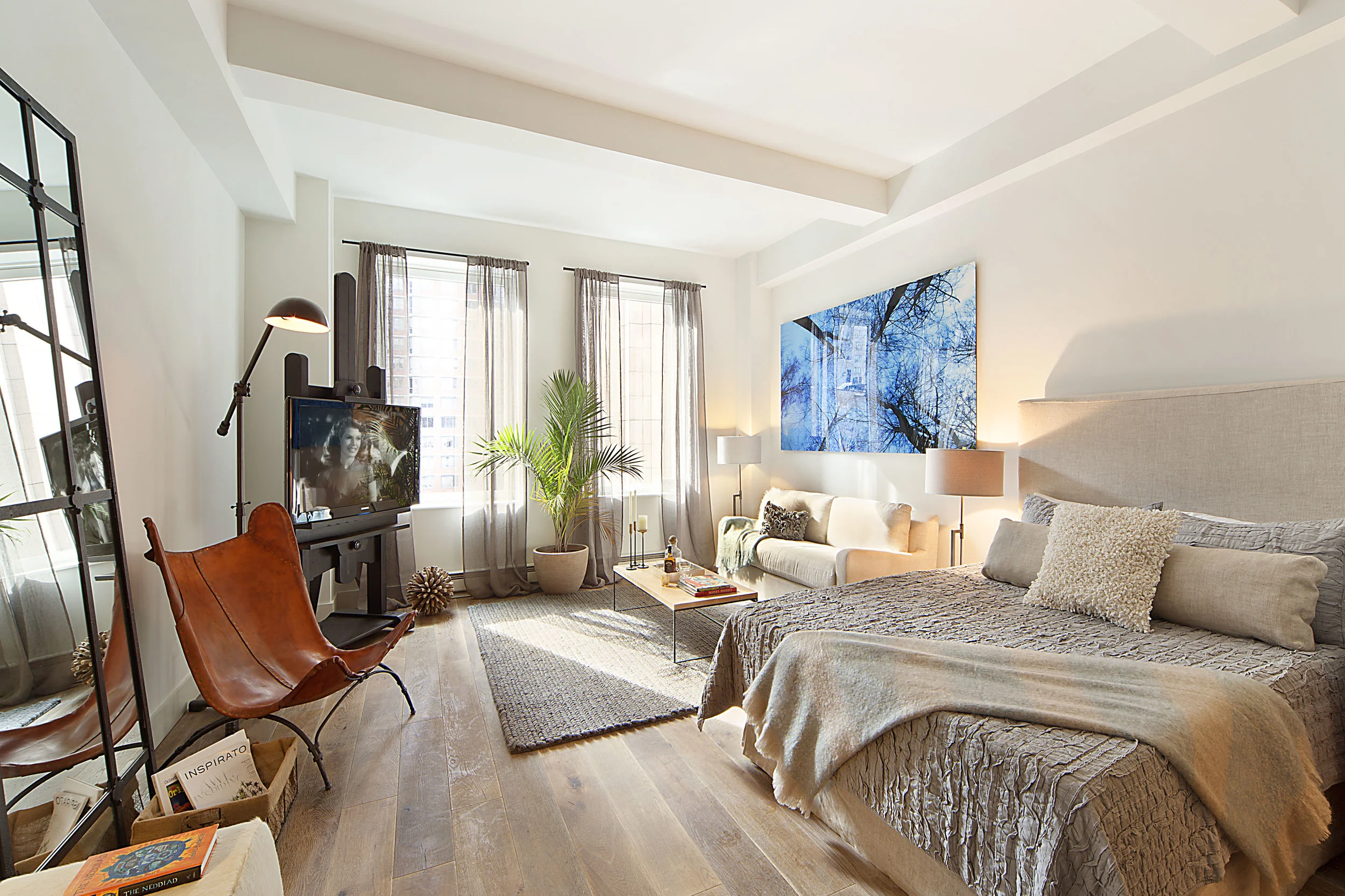 Studios can present one of the biggest challenges for layouts. We maximized this Tribeca studio with brightly colored modern art and a mirror to give the space definition.