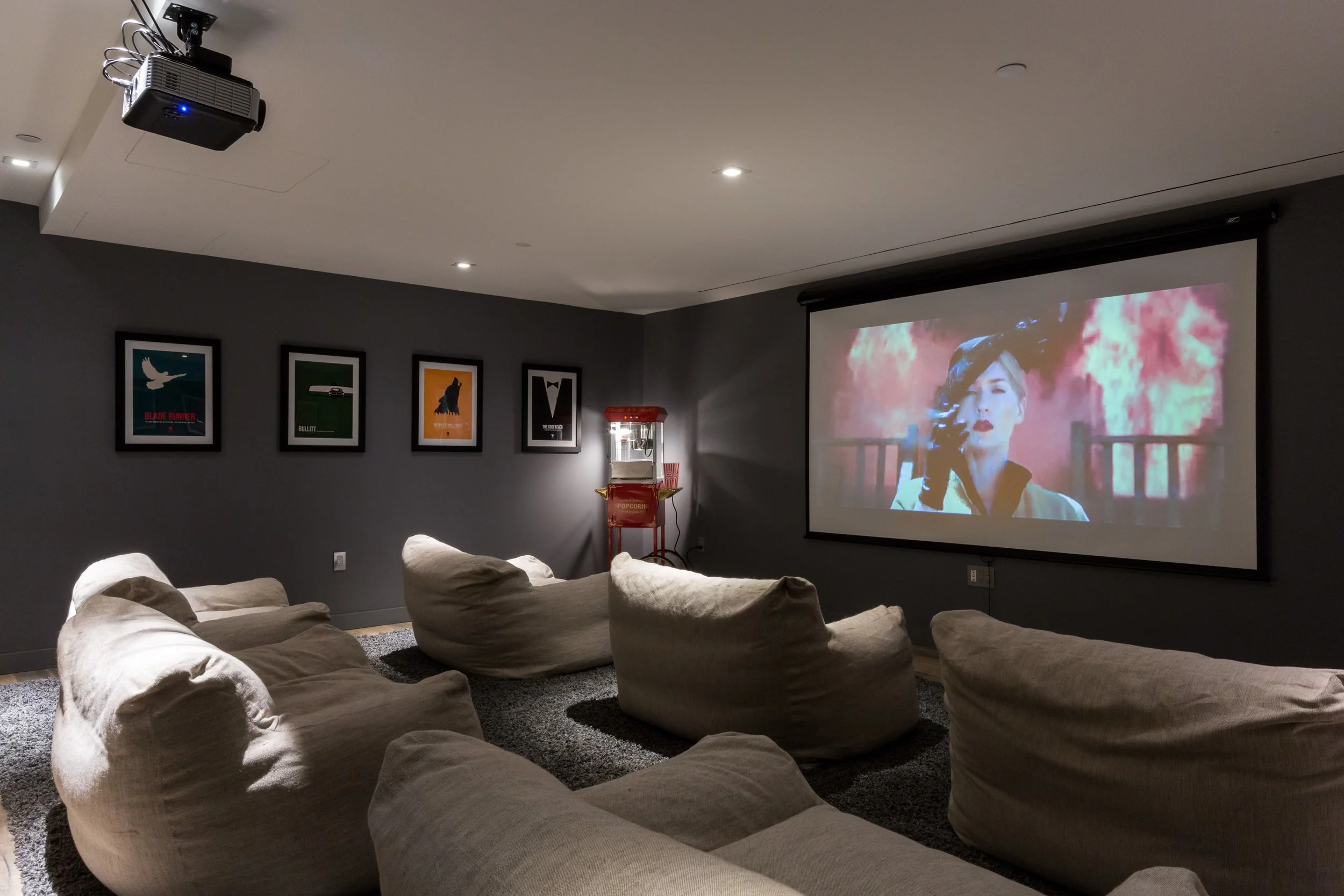 Instead of artwork or photography, we framed vintage movie posters in this basement renovation for an authentic theater impression.