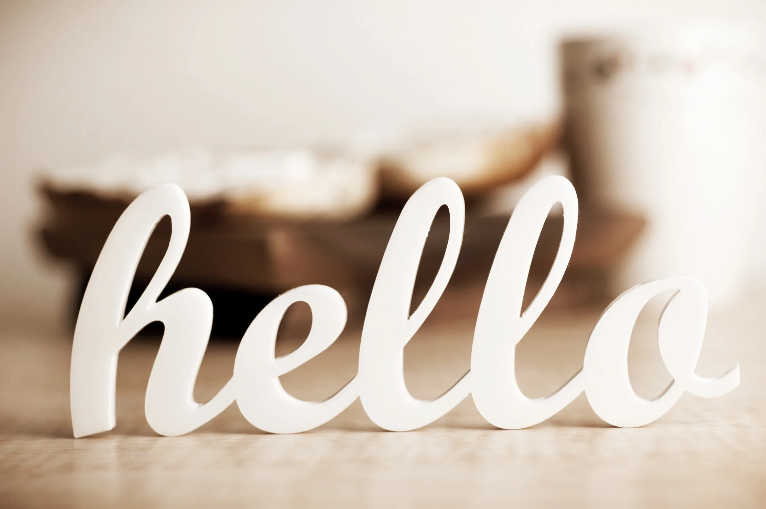 Cursive-hello-sign-with-blurred-breakfast-in-background-147518752_3008x2000.jpeg