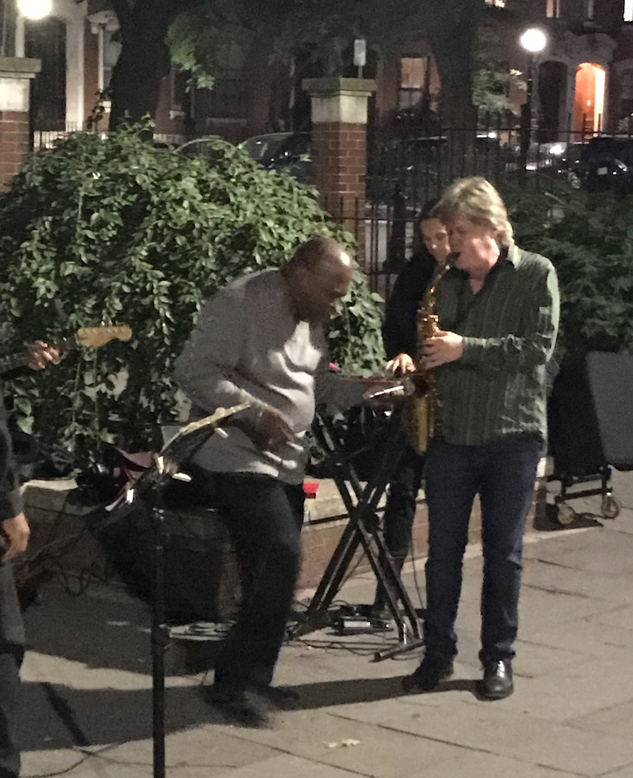 Pat Loomis , saxophone, and his 'walk-on' guest, soul singer Leon Beal, Jr . in Library Park, with Zayra Pola, on percussion, in the background
