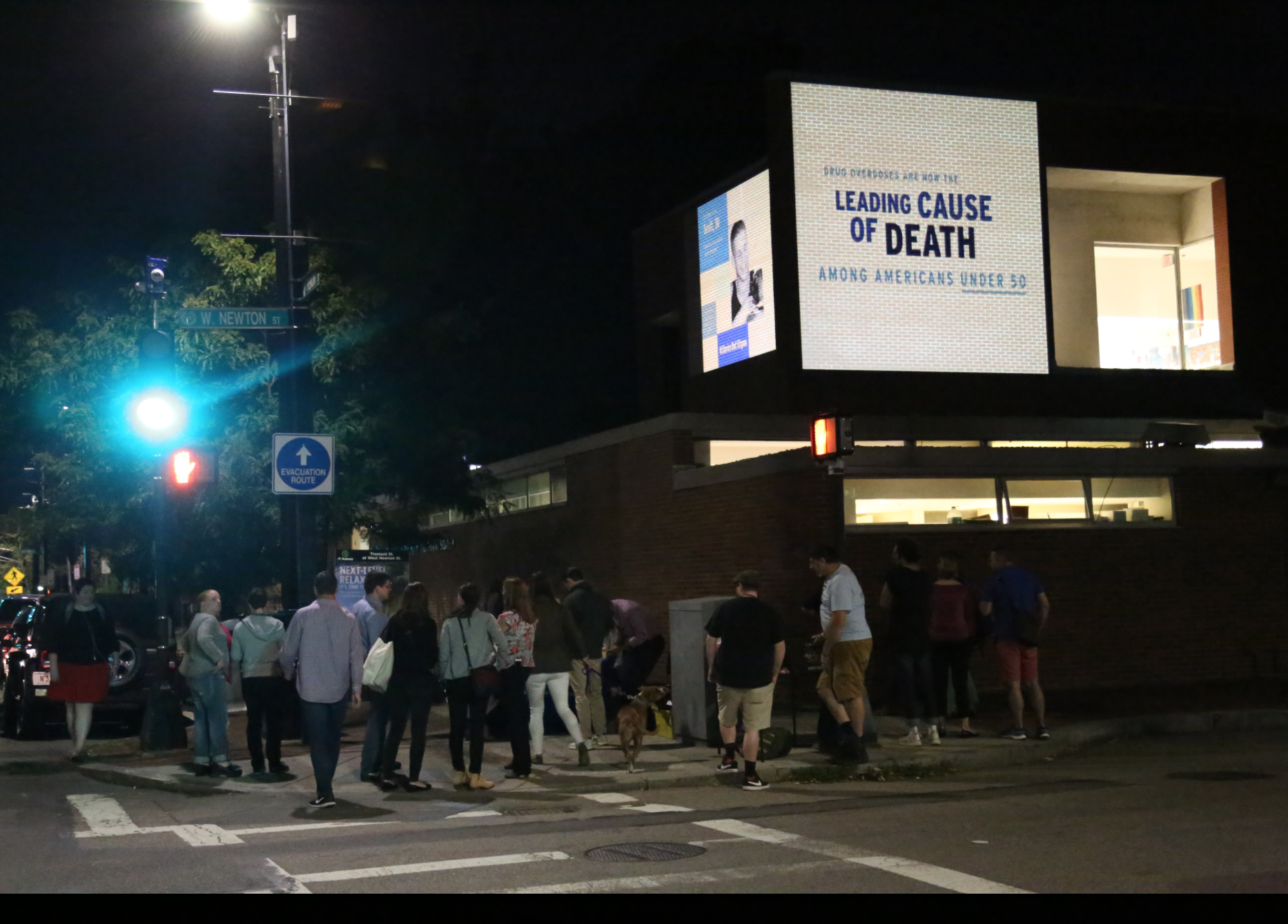 Images representing the urgency of the opioid crisis were projected on the walls of the South End library on the night of Thursday, August 31