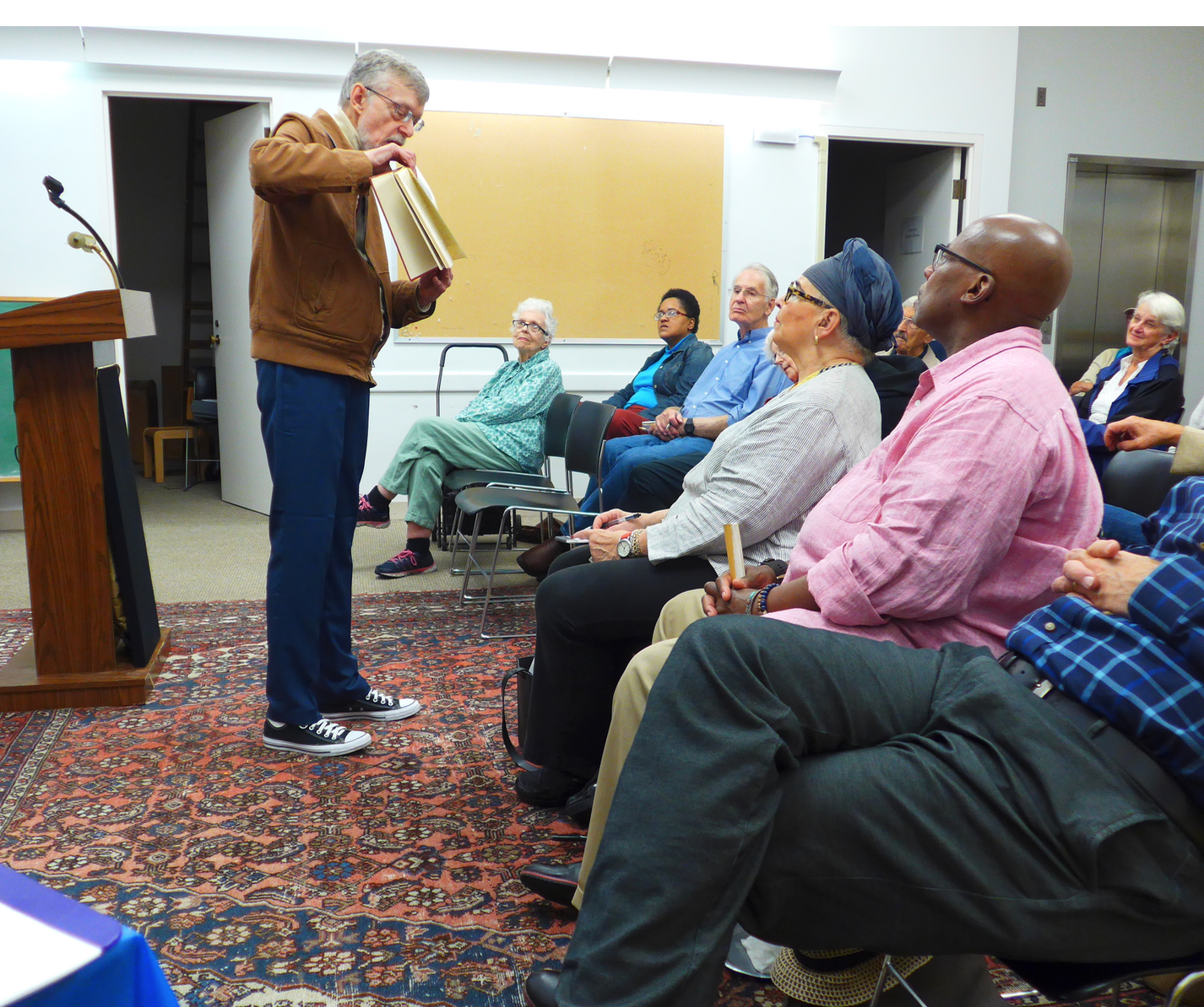 Longtime South End resident, local philanthropist and opera devotee, Randolph Fuller, showing the audience pictures of the demolished Boston Opera formerly located on Huntington Avenue