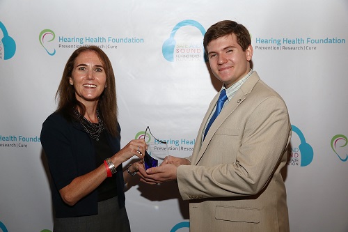 HHF Board Chair Shari Eberts presents Partner for Hearing Health award to Regal's Chris Chromey-Marquis
