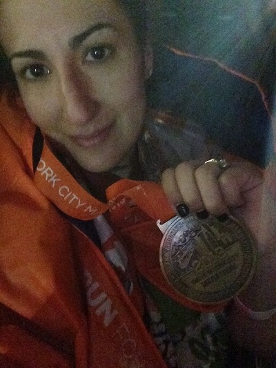 Veronica poses with her medal after finishing
