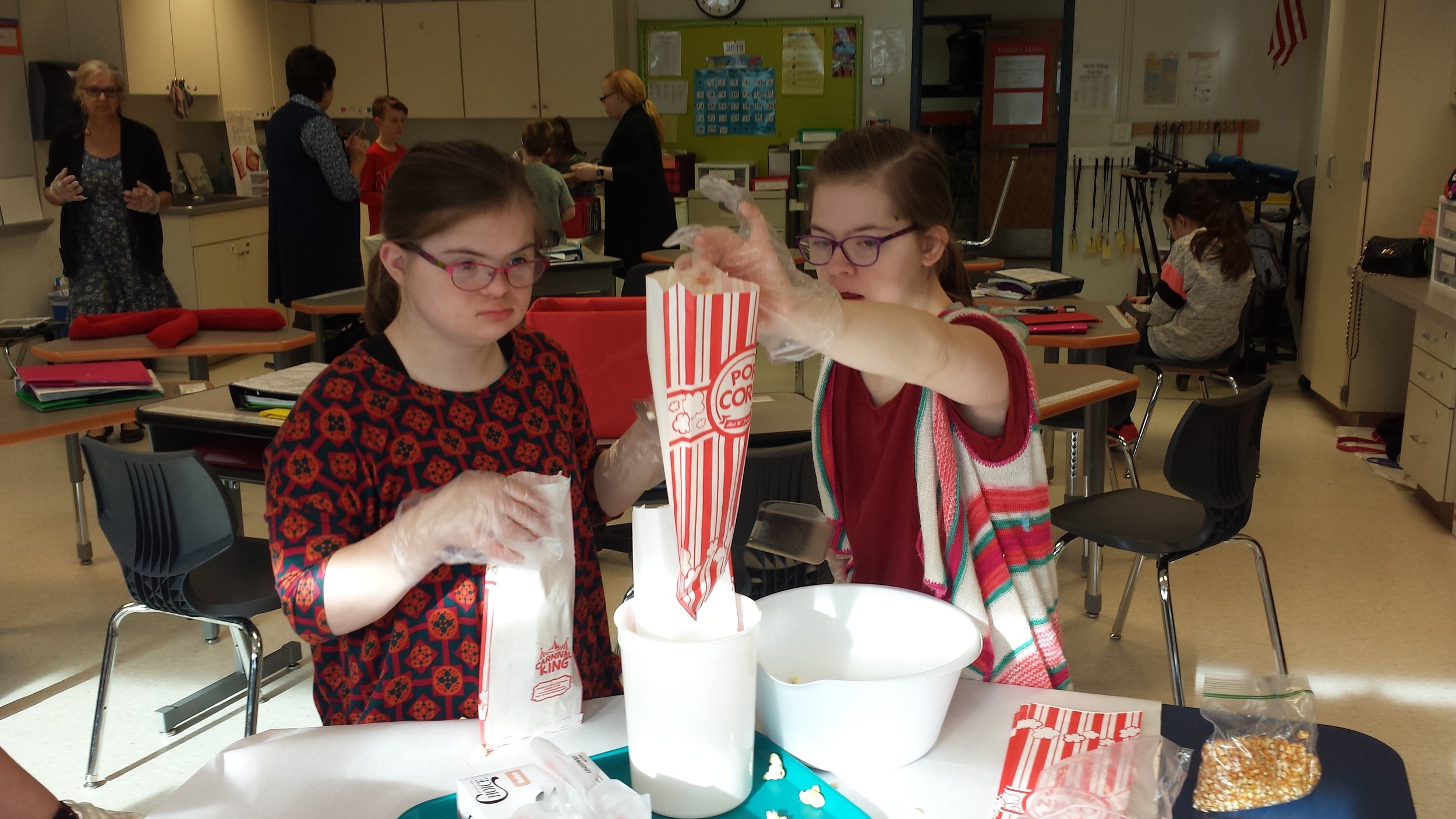 2 girls bagging popcorn approval on record.jpg