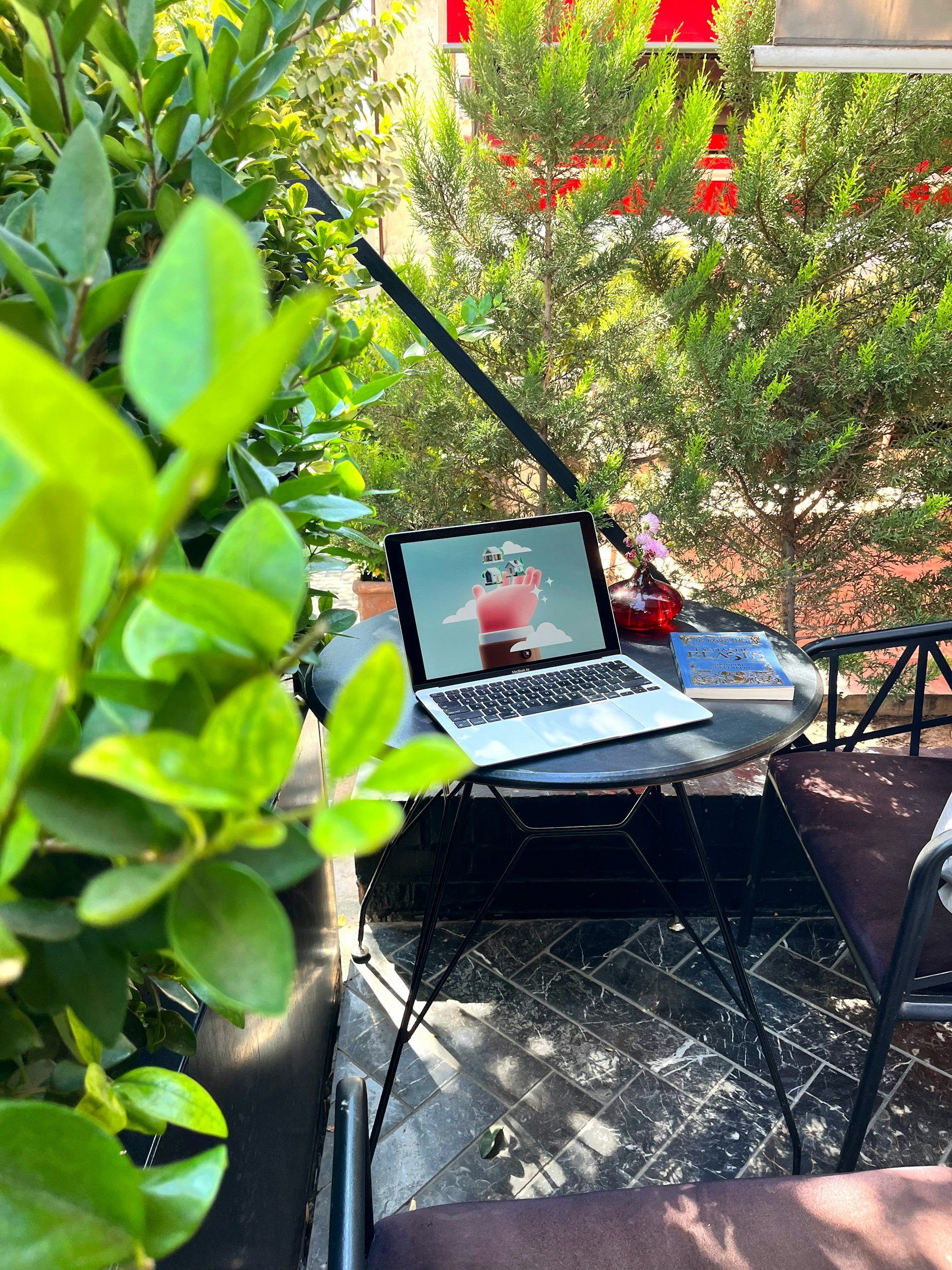 Laptop outside on a patio using outdoor Wi-Fi coverage