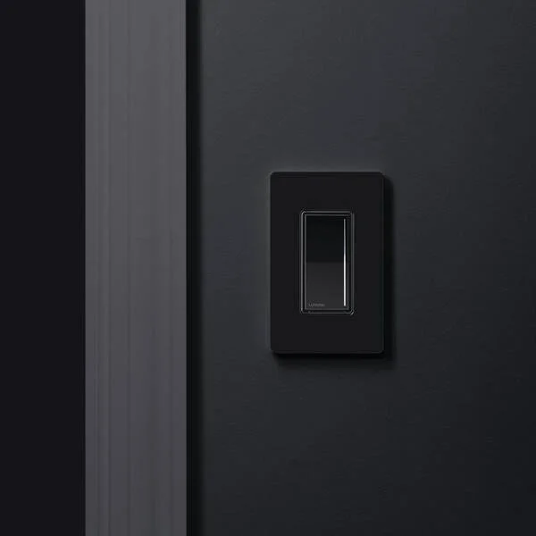 Black Lutron smart dimmer switch installed on wall