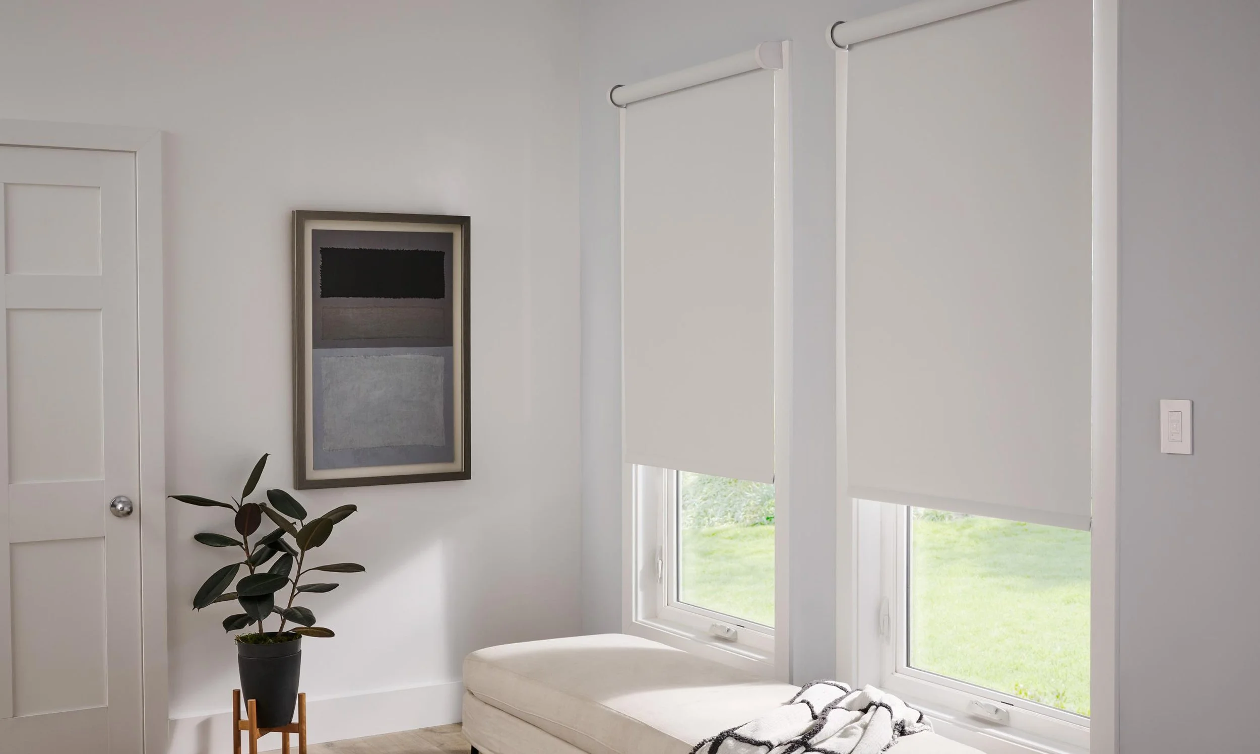 Motorized roller shades installed in a bedroom for privacy and natural light control