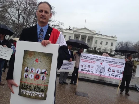 Abdulameer al-Hamdani holds a poster that says “Stop ISIS… Stop Terrorism… Save Mesopotamian Civilization.” (Photo credit: Marie-Helene Carleton, Four Corners Media, 2015)