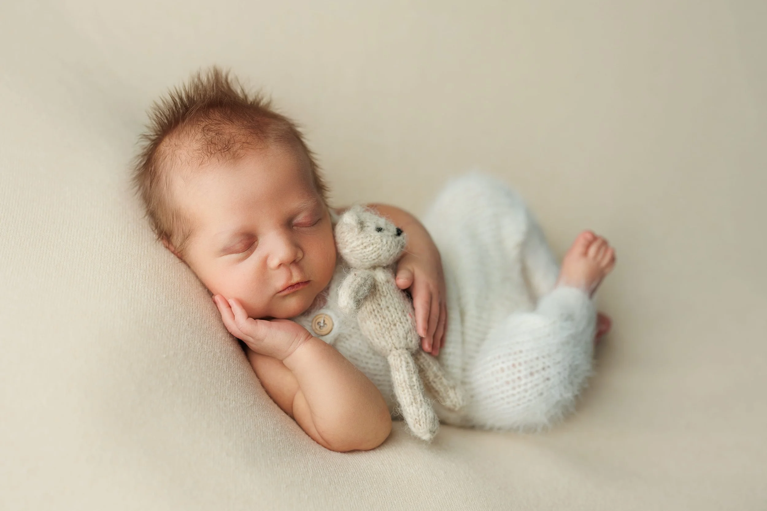 Studio newborn portrait in neutral tones