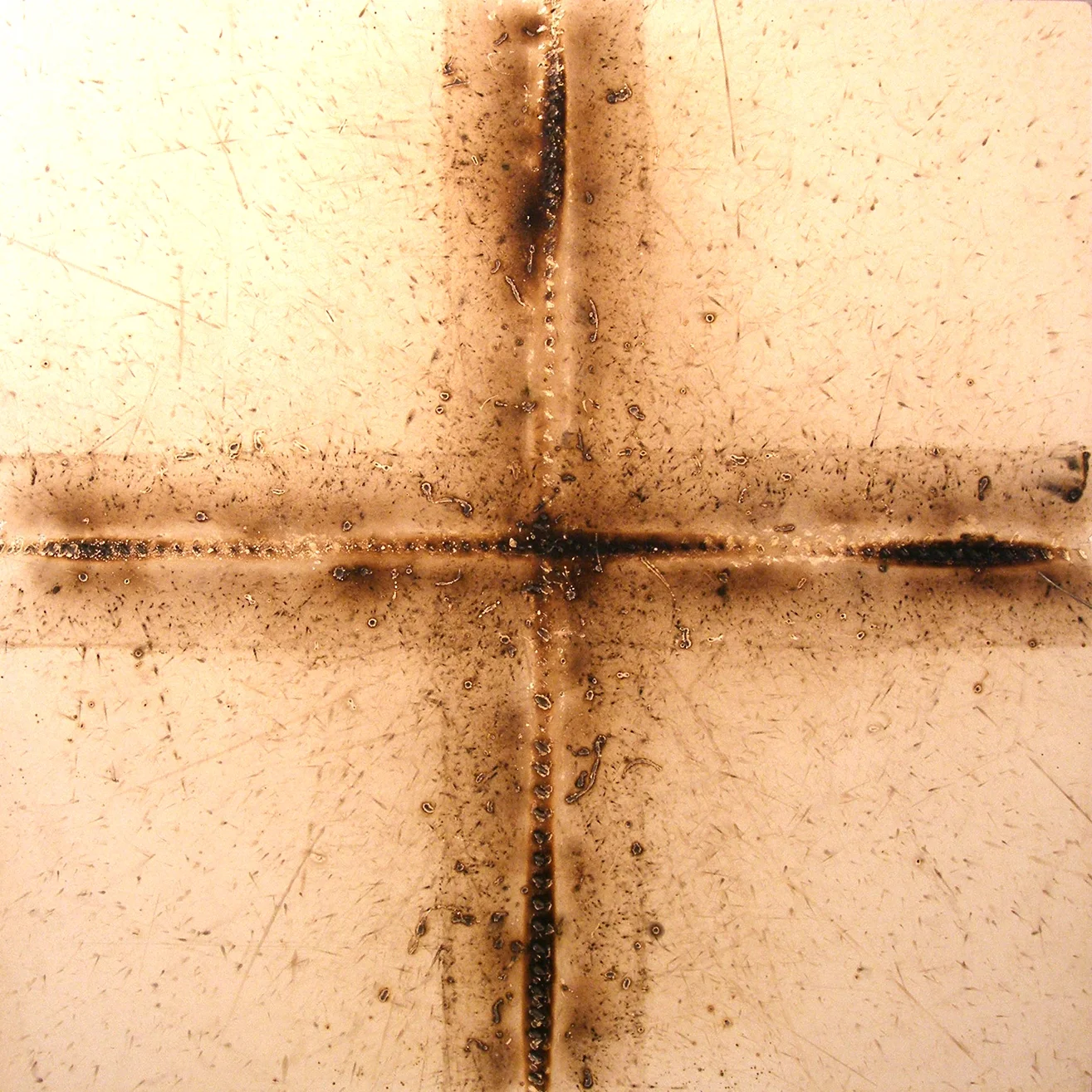   From “Cross” series, 20”X20”, weld splatter and heat on white panel, 2008  