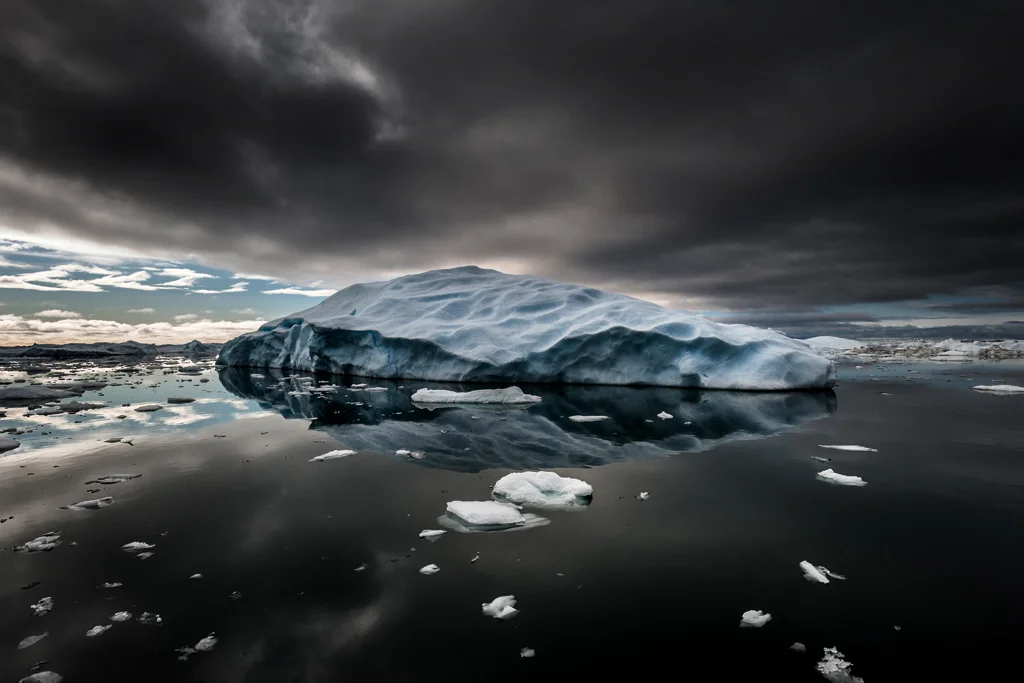 Iceberg in dark dramatic sea off the coast of Greenland