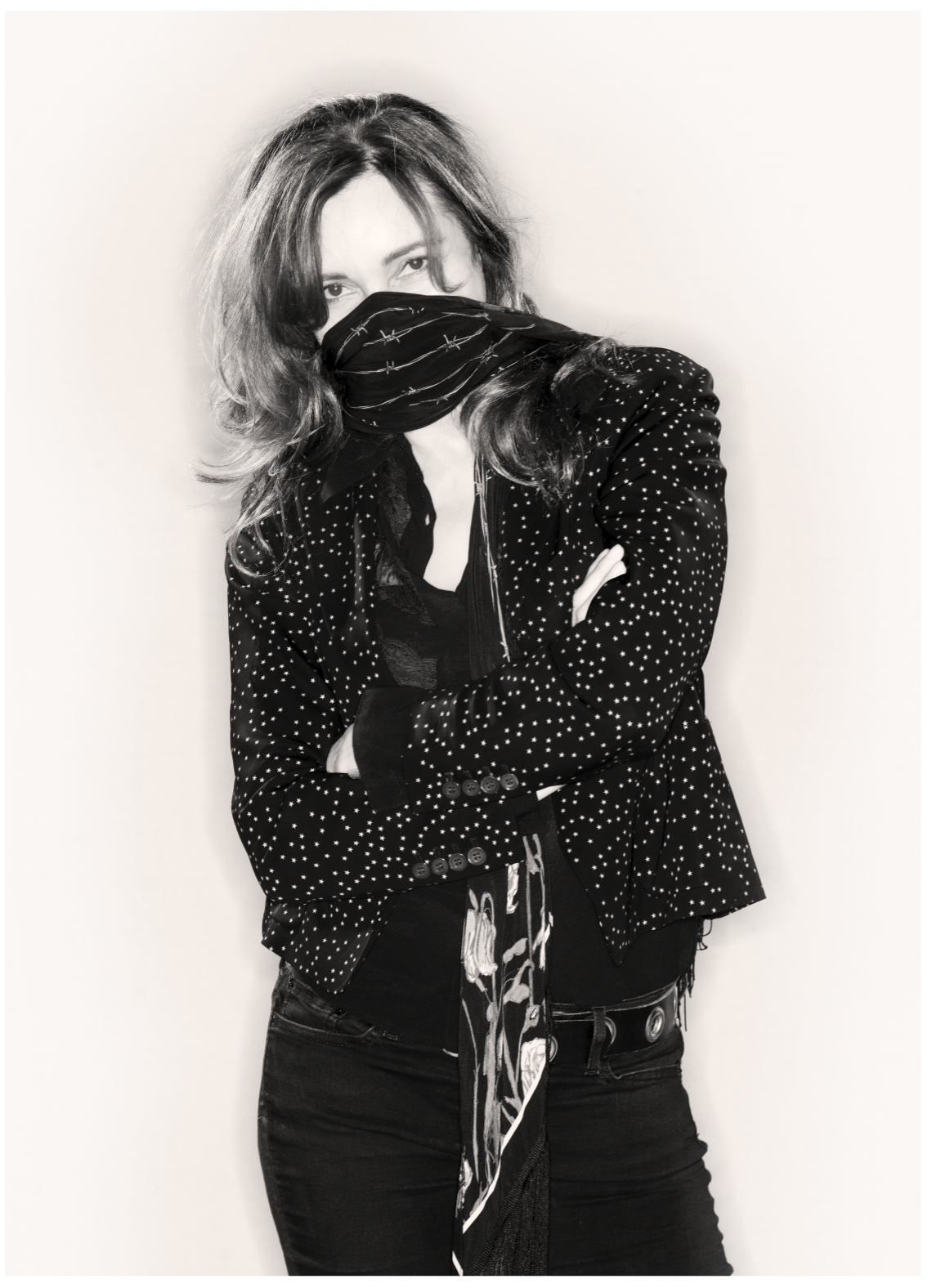 Viv Albertine wearing a scarf with barbed wire printed on it pulled up across her mouth