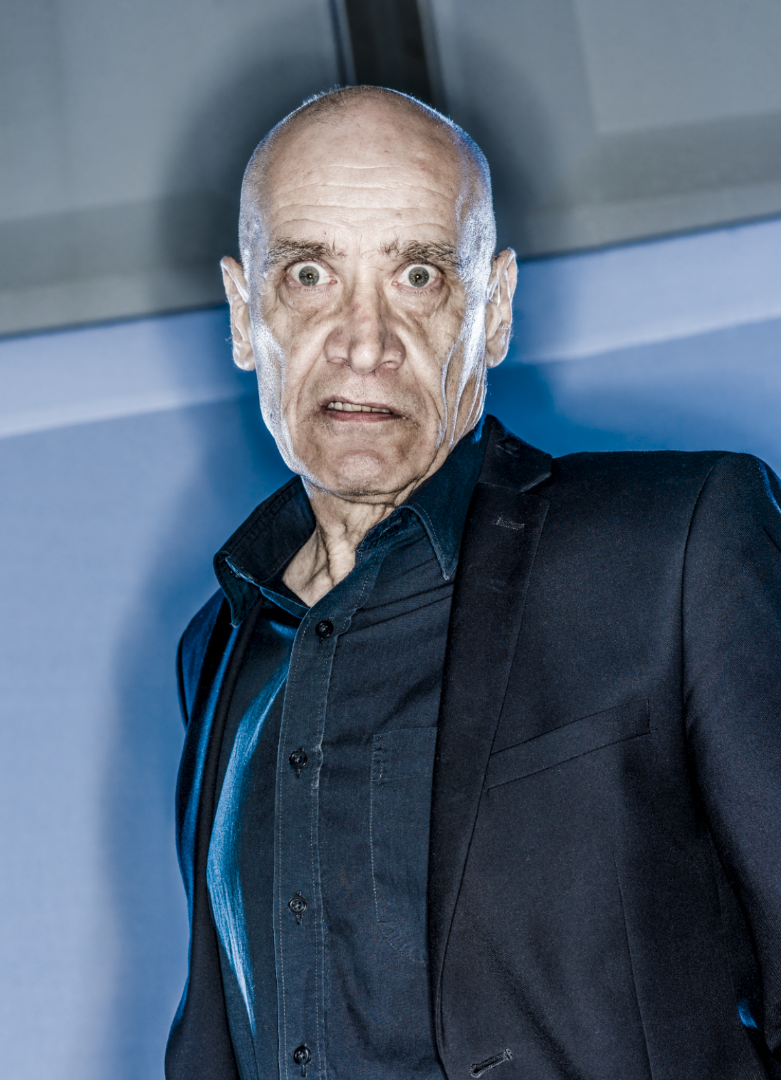 Wilco Johnson an older man is scowling at camera